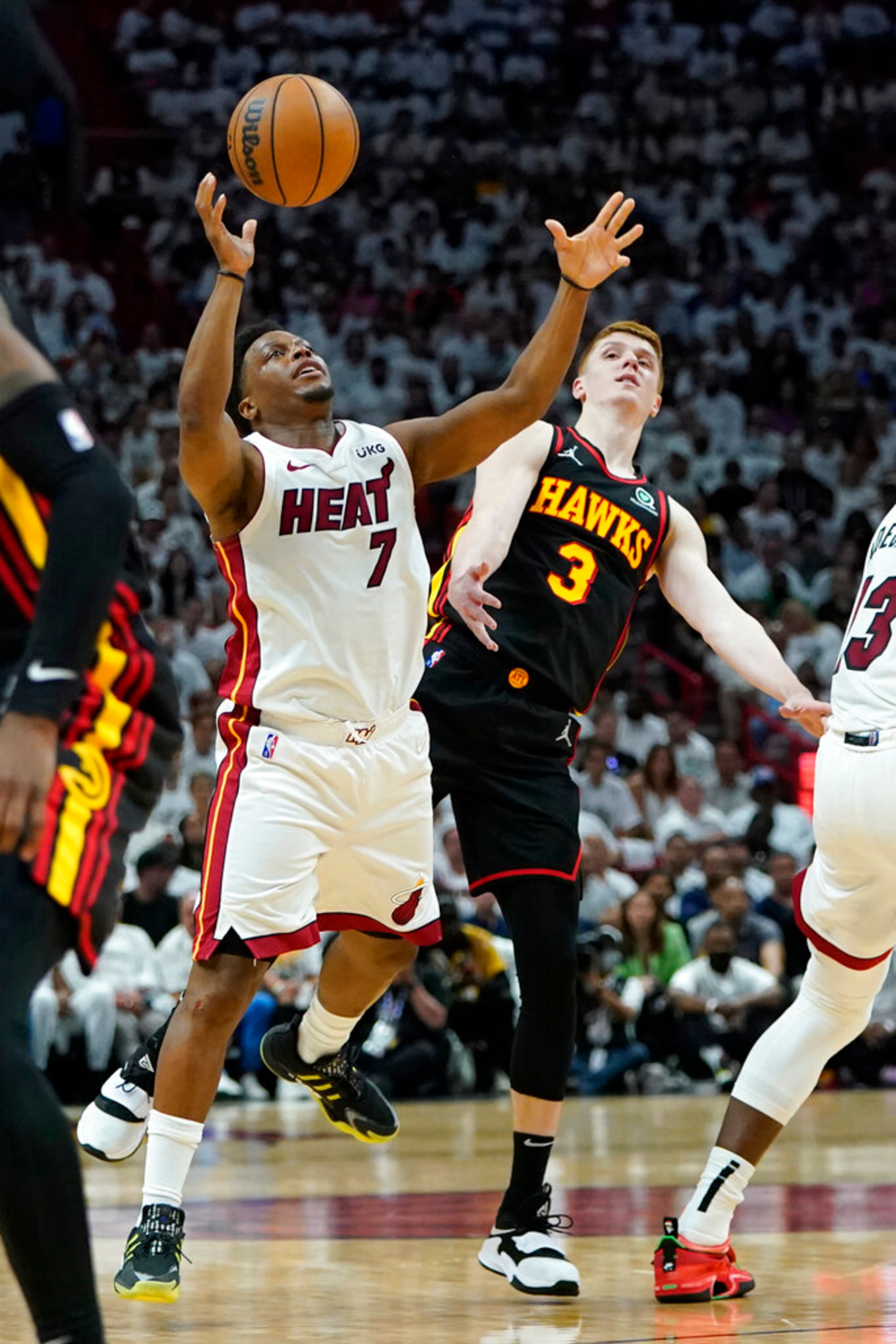 Miami Heat guard Kyle Lowry (7) is fouled by Atlanta Hawks guard Kevin Huerter (3) during the first half of Game 2 of an NBA basketball first-round playoff series, Tuesday, April 19, 2022, in Miami. (AP Photo/Lynne Sladky)