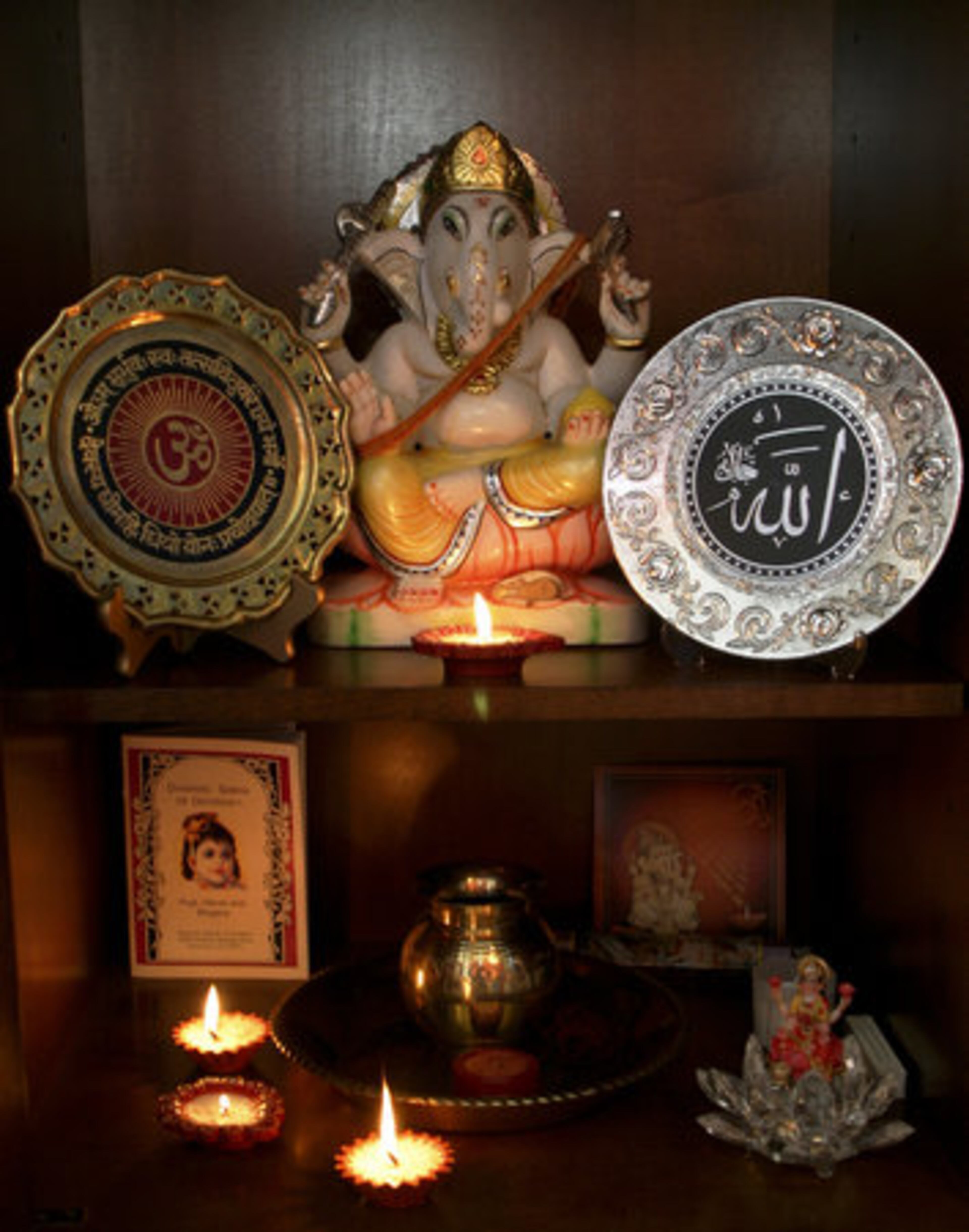 "We're both Guyanese but I'm Hindu and Saif is Muslim. We both share the same faith and believe in each other's values. The Ganesh (top center) in the middle room is really where I do all of my prayers," says Miranda, "you'll see there's a Hindu plate (left) and a Muslim plate side by side. Per Saif, "The Islamic plate is the opening of the Koran." Miranda adds, "The Hindu plate is the symbol of 'Om.' The statue is a murti, a gift from my mother. The plate below is from our wedding ceremony."