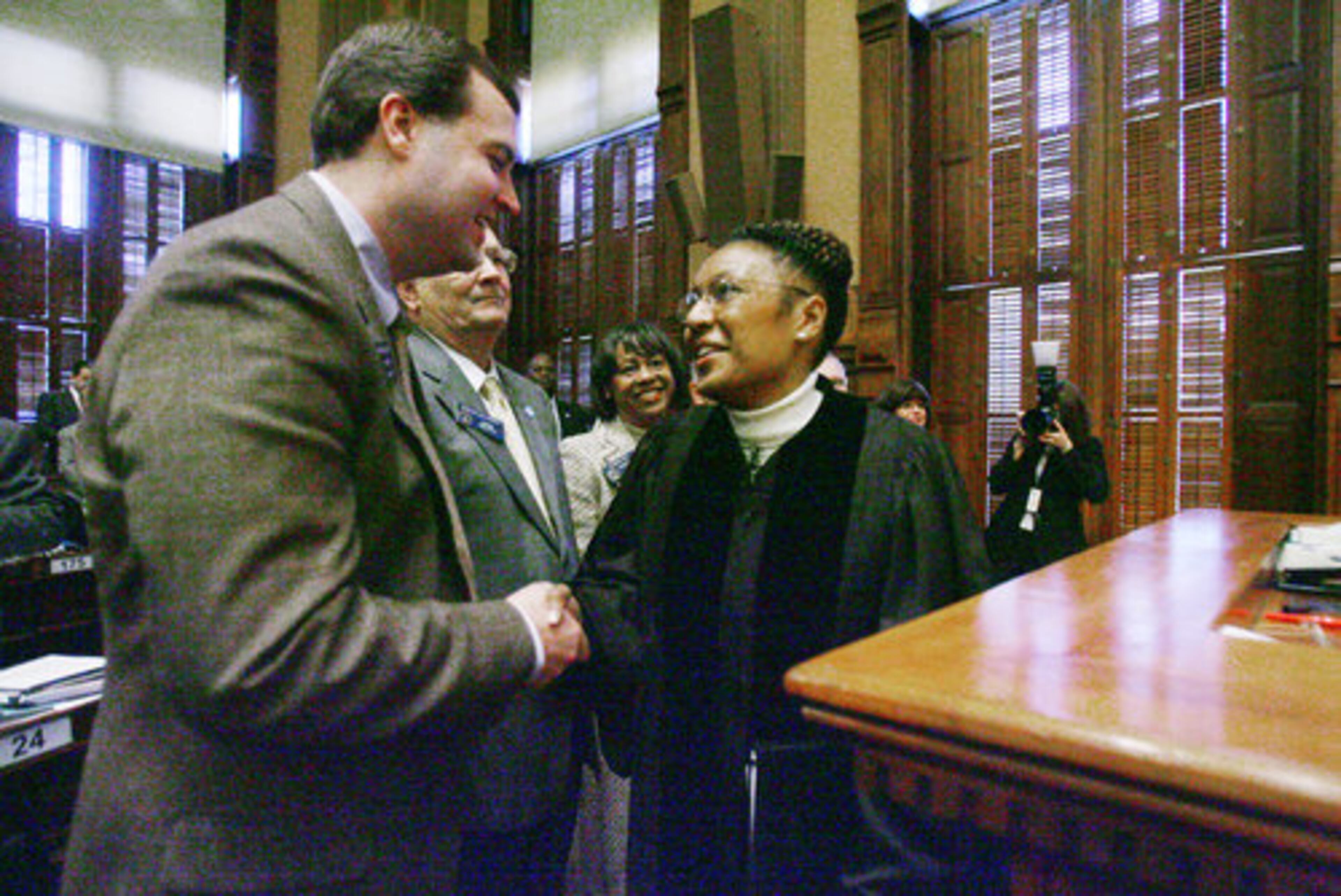 Sen. Preston Smith (left) R-Rome, chairman of the Senate Judiciary Committee, congratulates Chief Justice Leah Ward Sears.