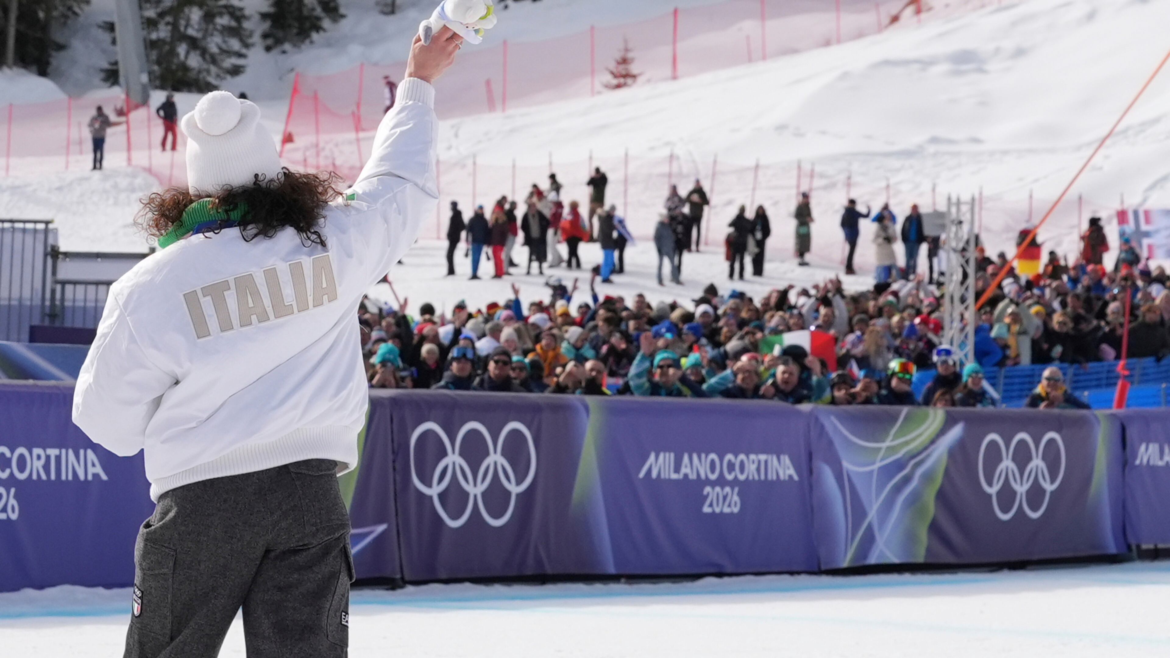 Italy's Federica Brignone, gold medalist in an alpine ski, women's super-G race, waves to supporters at the 2026 Winter Olympics, in Cortina d'Ampezzo, Italy, Thursday, Feb. 12, 2026. (AP Photo/Jacquelyn Martin)