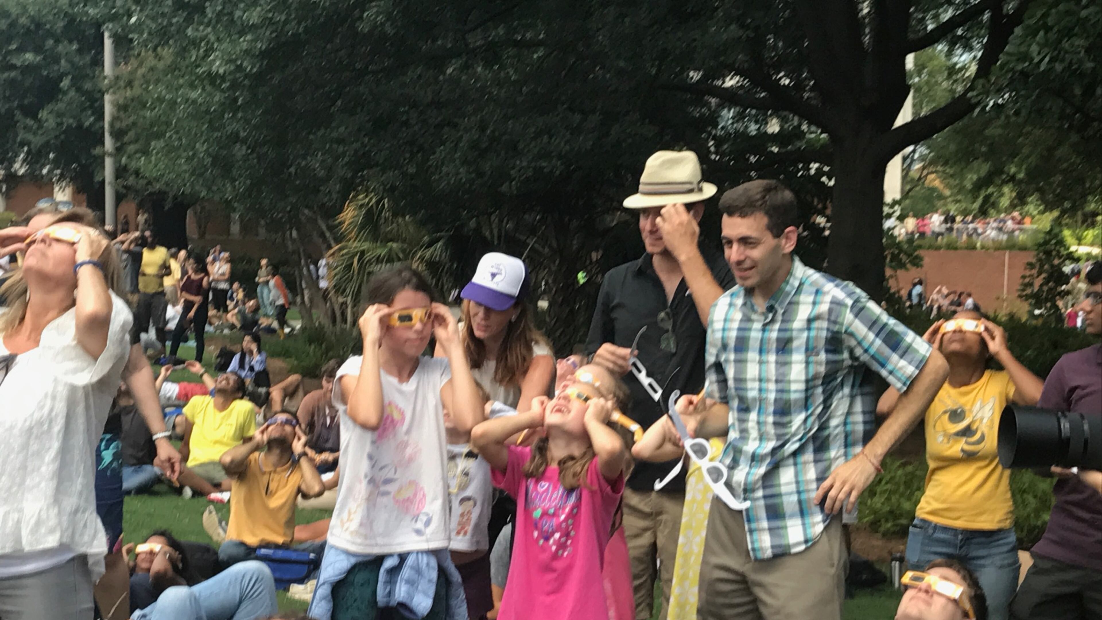 Georgia Tech students, faculty and visitors peer into the sky at the height of Monday's solar eclipse. ERIC STIRGUS / ESTIRGUS@AJC.COM