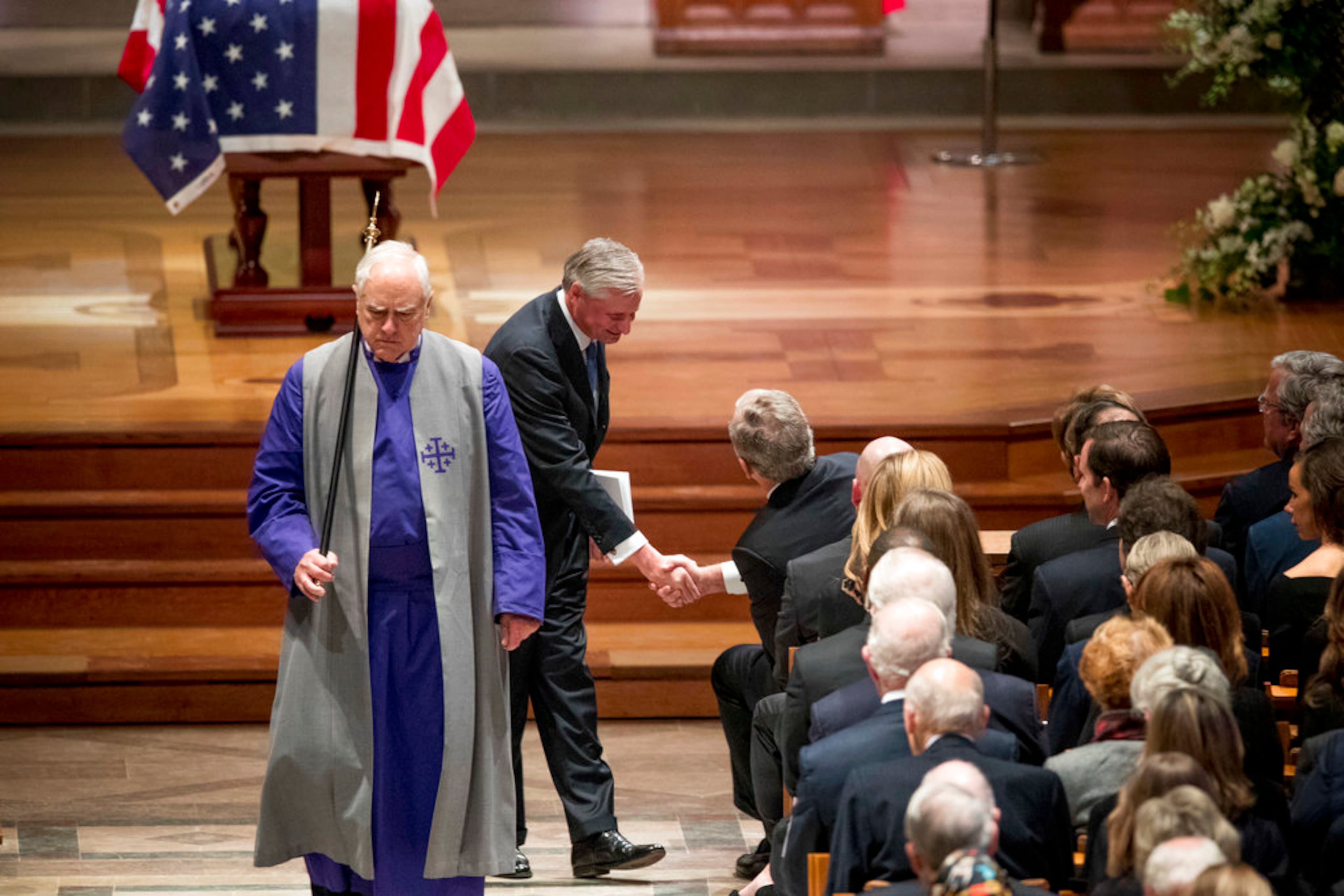 Presidential biographer Jon Meacham, second from left, shakes hands with former President George Bush after speaking during the State Funeral for former President George H.W. Bush at the National Cathedral, Wednesday, Dec. 5, 2018, in Washington. (AP Photo/Andrew Harnik, Pool)