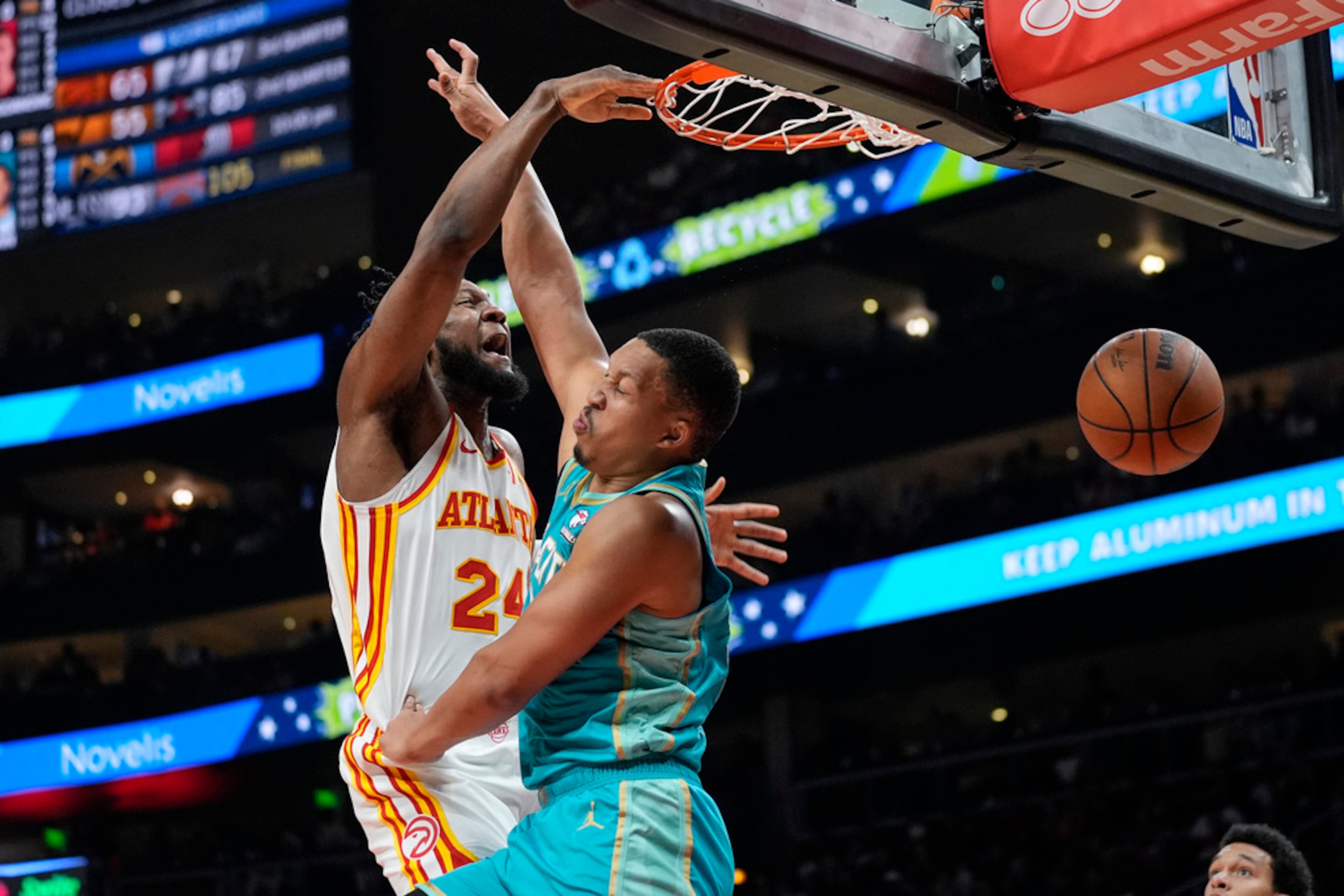 Atlanta Hawks forward Bruno Fernando (24) dunks as Charlotte Hornets forward Grant Williams (2) defends during the second half of an NBA basketball game Saturday, March 23, 2024, in Atlanta. The Hawks won 132-91. (AP Photo/John Bazemore)