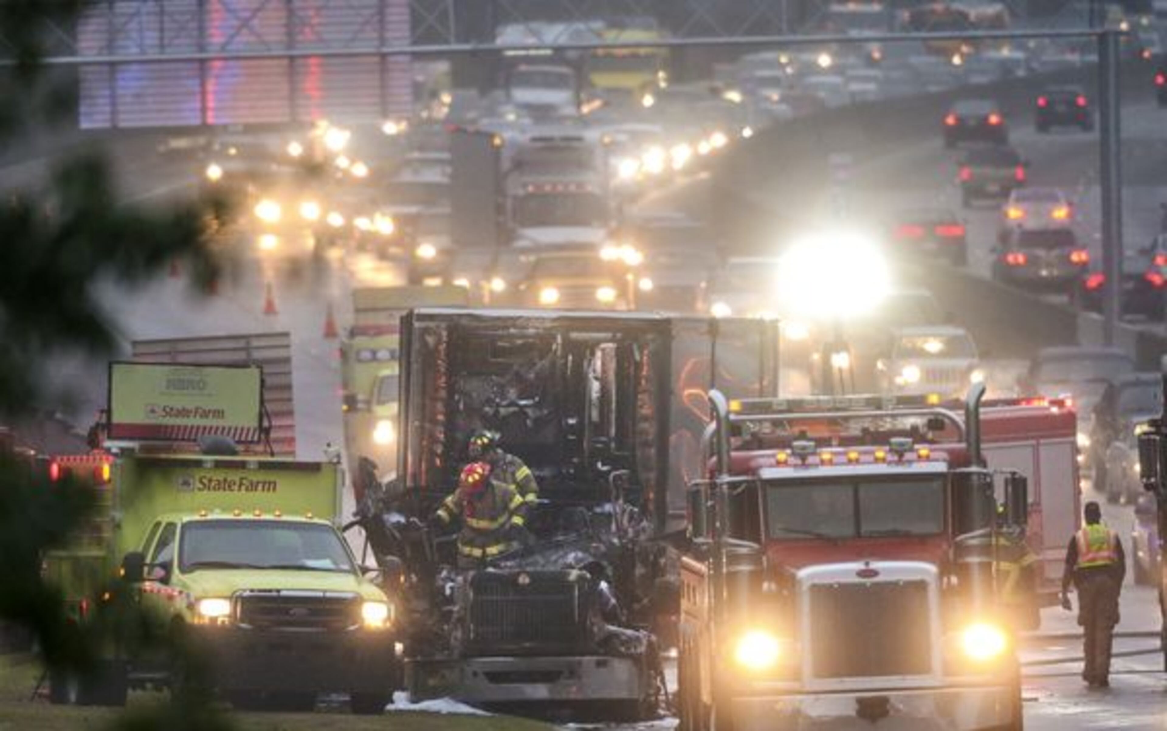 DeKalb County Firefighters emerge from the cab of a burned out truck Thursday morning, Nov. 5, 2015 after putting out a fire that erupted during the early morning commute.