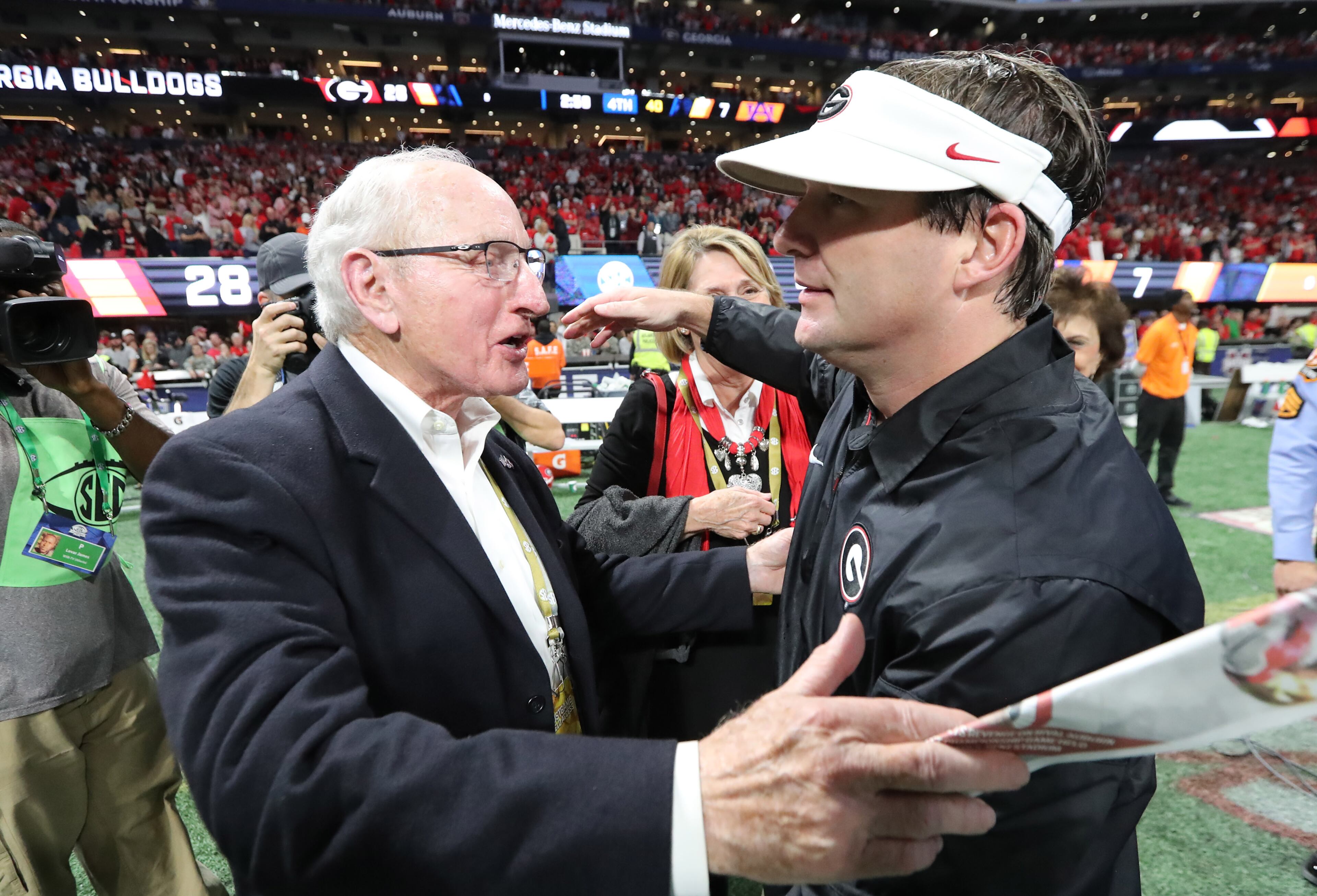 December 2, 2017 Atlanta: Former Georgia athletic director Vince Dooley (L) and head coach Kirby Smart celebrate after the Bulldogs defeated Auburn 28-7 during the SEC Football Championship at Mercedes-Benz Stadium, December 2, 2017, in Atlanta. Curtis Compton / ccompton@ajc.com