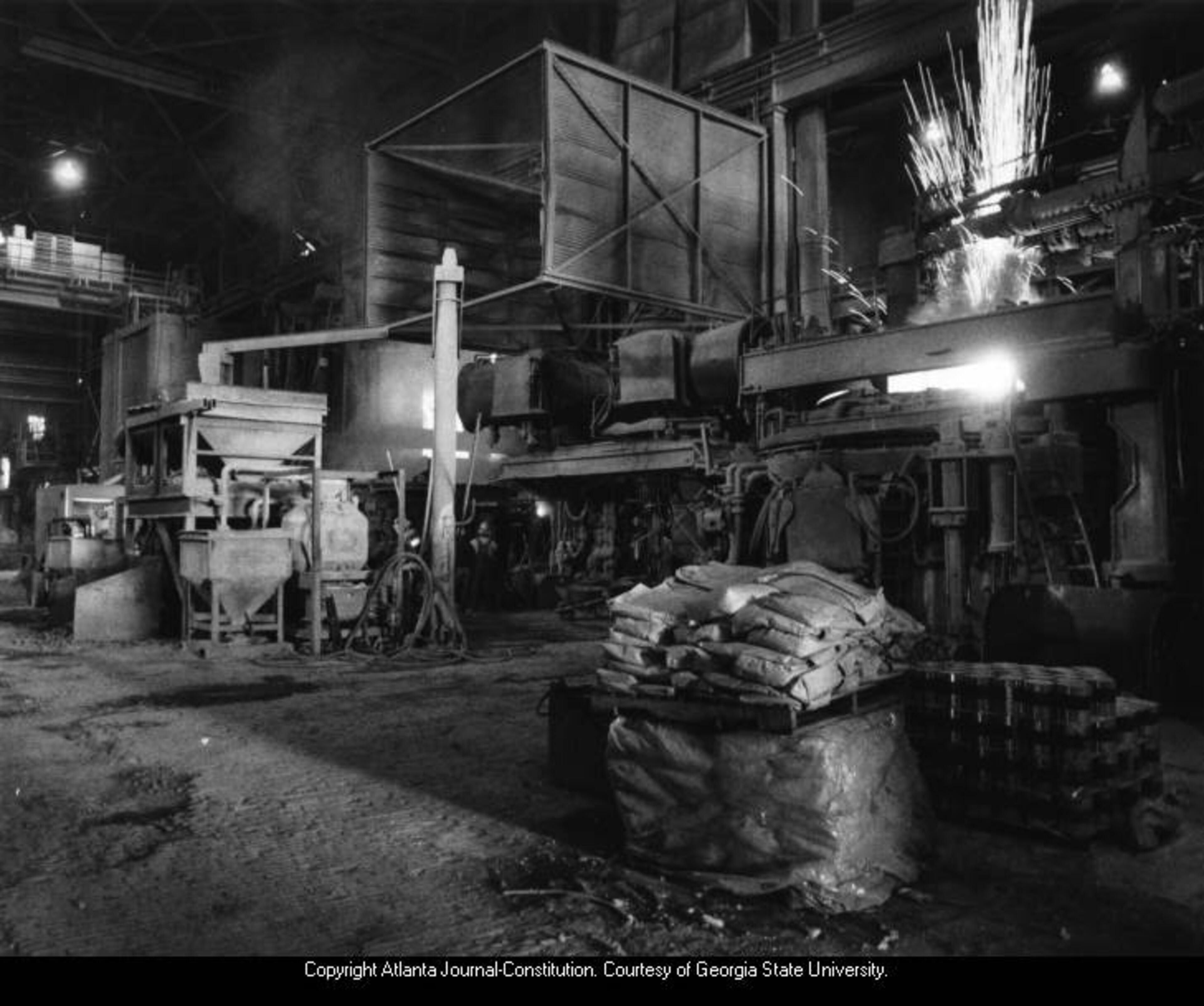 1985 -- Sparks flare from one of two furnaces used to melt scrap metal into molten steel at the Atlantic Steel Company. NEIL McGAHEE / AJC FILE