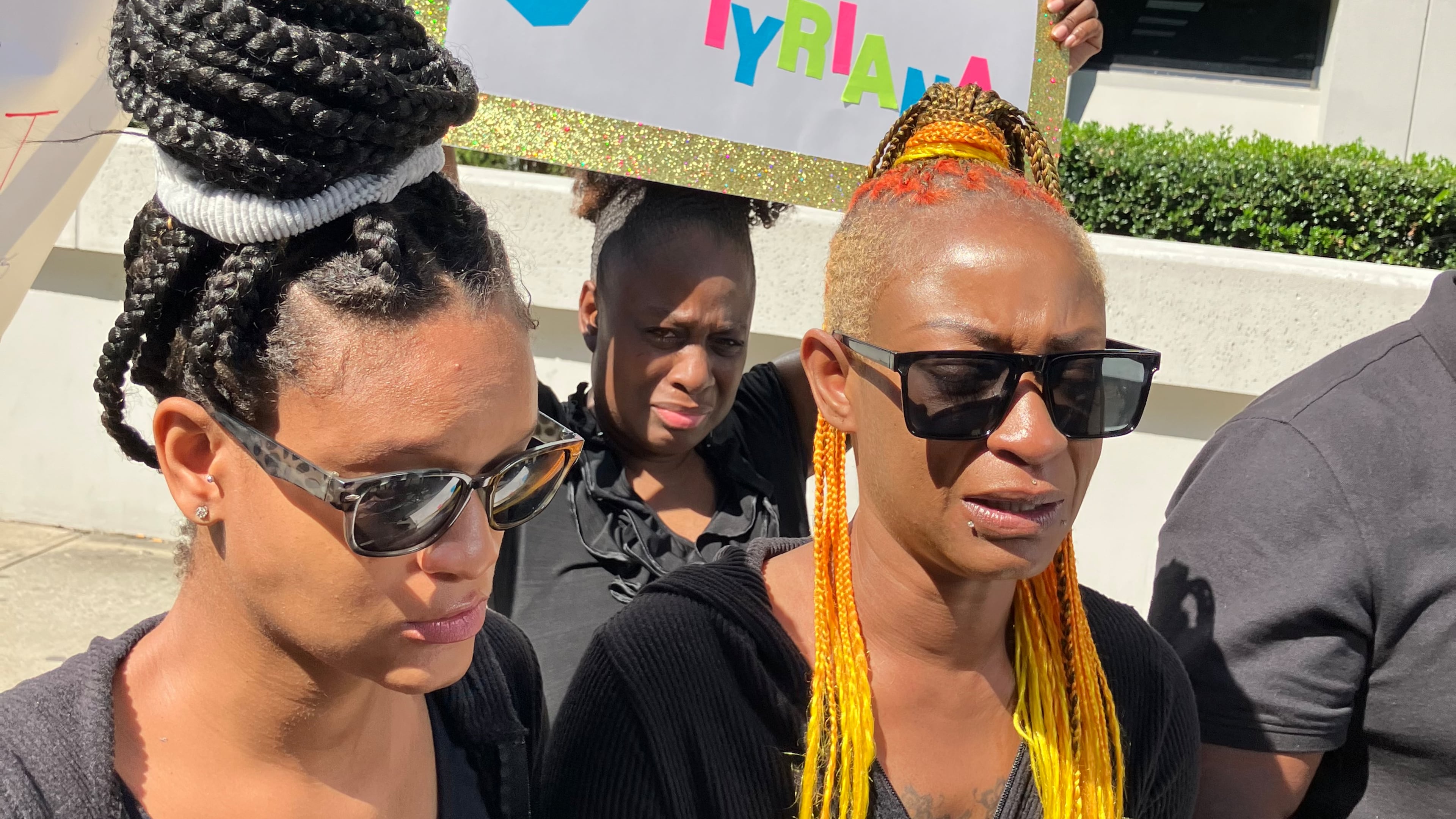 Gloria Buckner, right, discusses an attack on her daughter, Tyriana Ledbetter, at the Fulton County Jail that left Ledbetter critically injured, at a news conference outside the Fulton County Sheriff's Office on Thursday, Oct. 2. Buckner stands with her other daughter, Tyshun Barney, left. (Reed Williams/AJC)