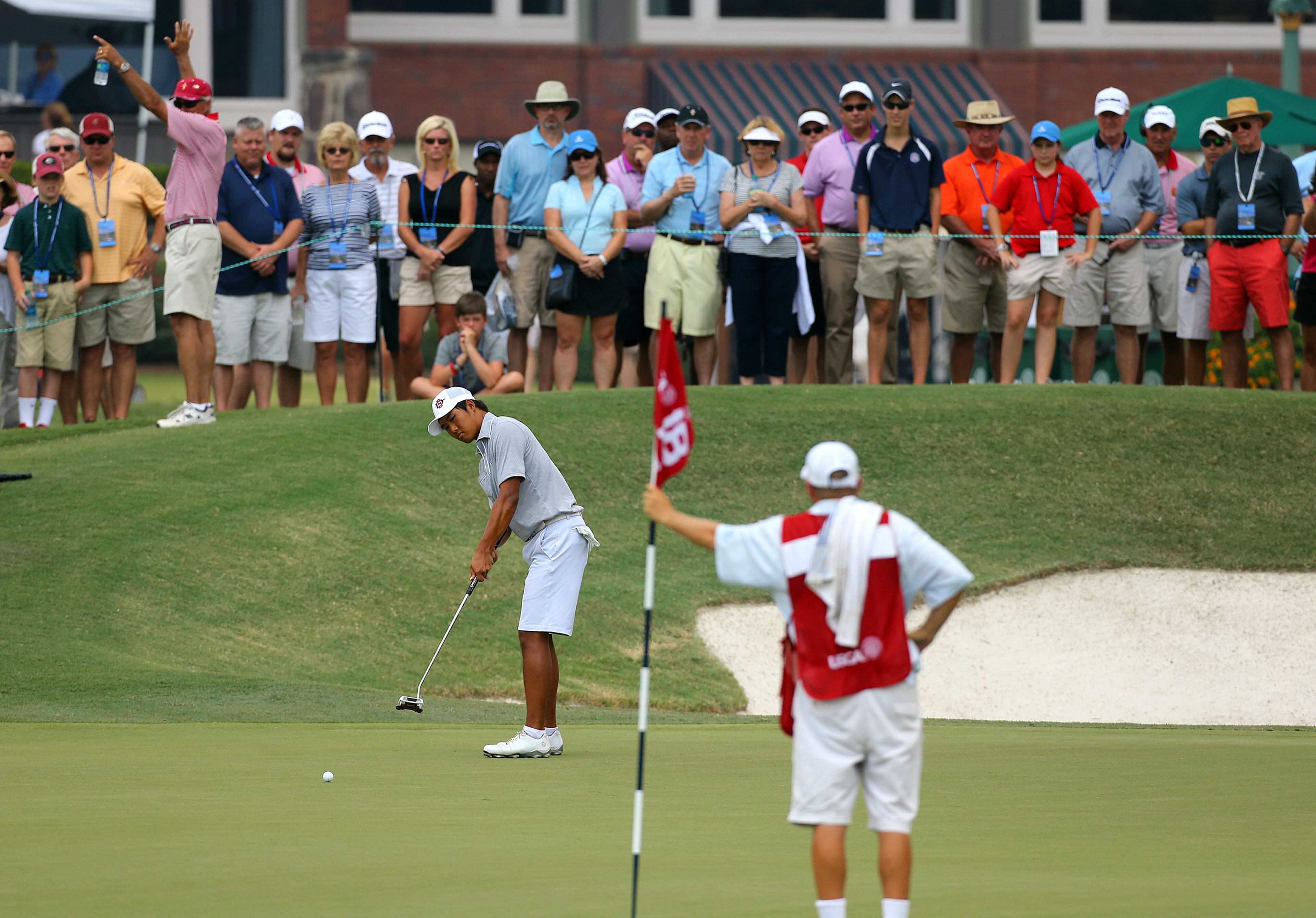 Gunn Yang, San Diego, California, misses his birdie putt on the 18th green losing the hole to Corey Conners during the morning session of the 36-hole championship match of the 2014 U.S. Amateur Championship at Atlanta Athletic Club on Sunday, August 17, 2014, in Johns Creek.
