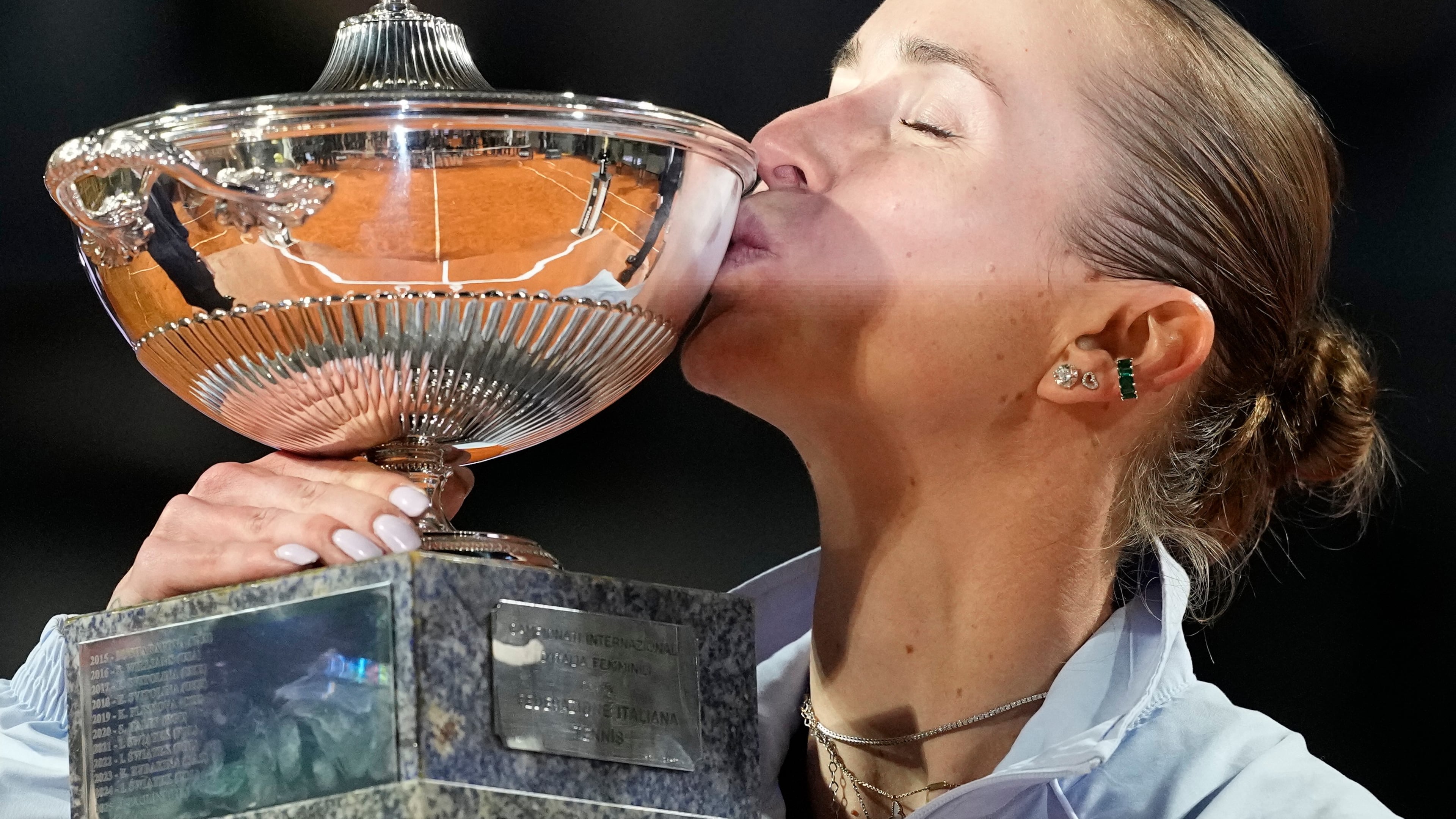Ukraine's Elina Svitolina kisses the trophy after winning against United States' Coco Gauff at the end of the women's final match at the Italian Open tennis tournament in Rome, Saturday, May 16, 2026. (AP Photo/Alessandra Tarantino)