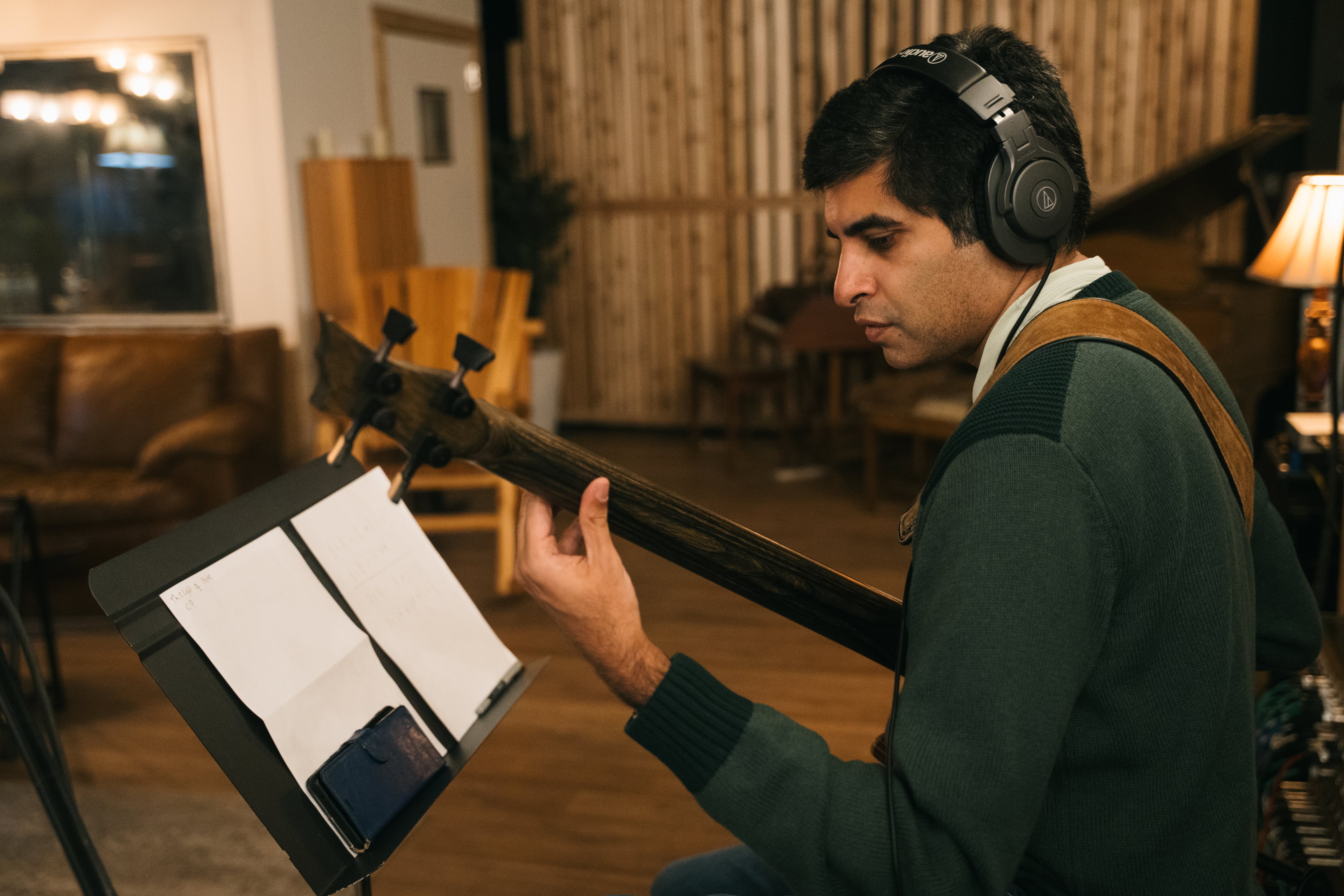 Kabir Sehgal plays bass during a recording session at Tree Sound Studios. (Olivia Bowdoin/AJC)