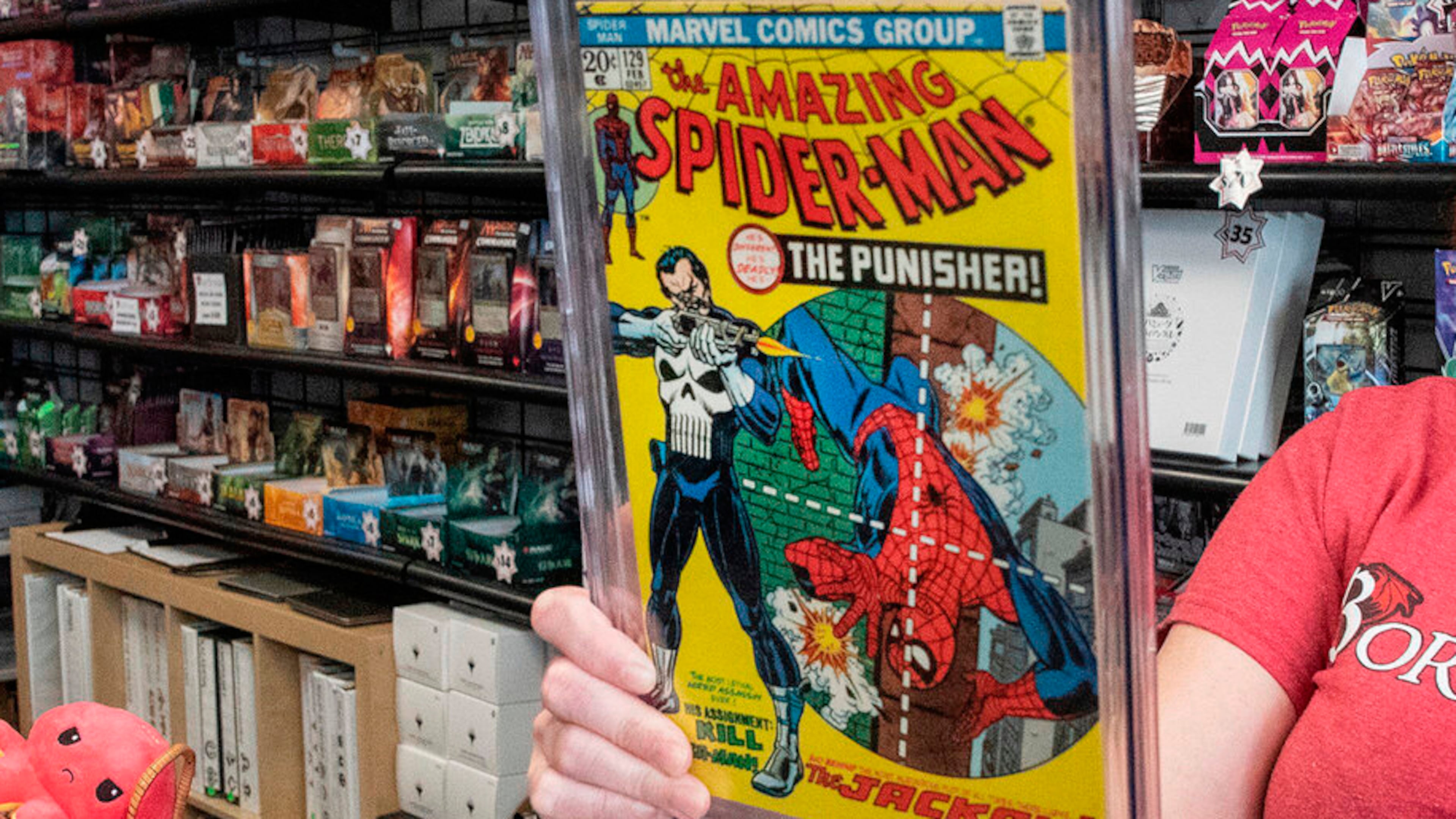 FILE - A game store manager holds the graded AM129 Spiderman "The Punisher" first issue on Sept. 10, 2021, in South Dover, Del. (Marc Clery/Delaware State News via AP, File)
