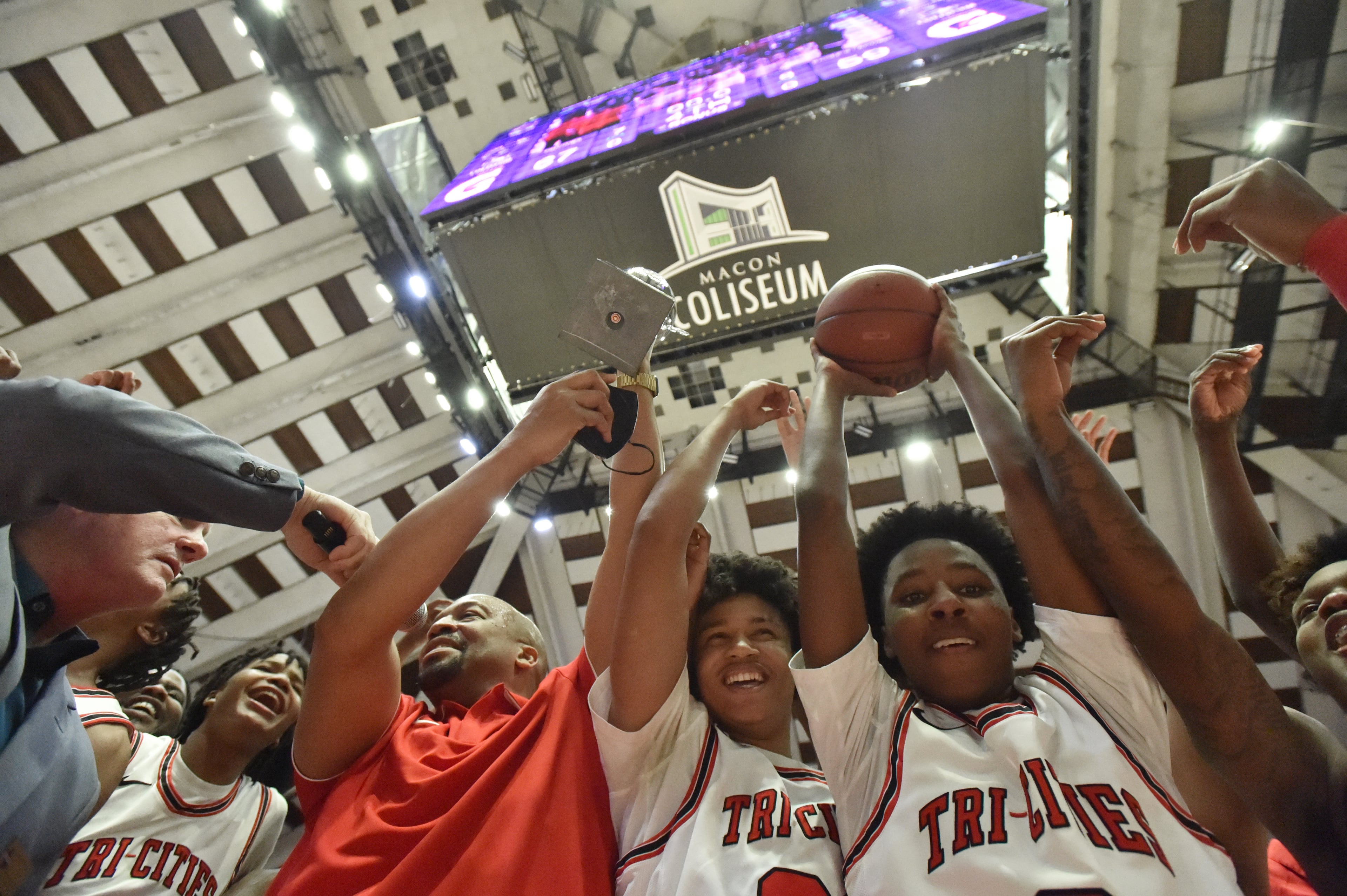 Tri-Cities' head coach Omari Forts and his players celebrate their victory over Eagle's Landing during the 2022 GHSA State Basketball Class AAAAA Boys Championship game at the Macon Centreplex in Macon on Thursday, March 10, 2022. Tri-Cities won 67-59 over Eagle's Landing. (Hyosub Shin / Hyosub.Shin@ajc.com)