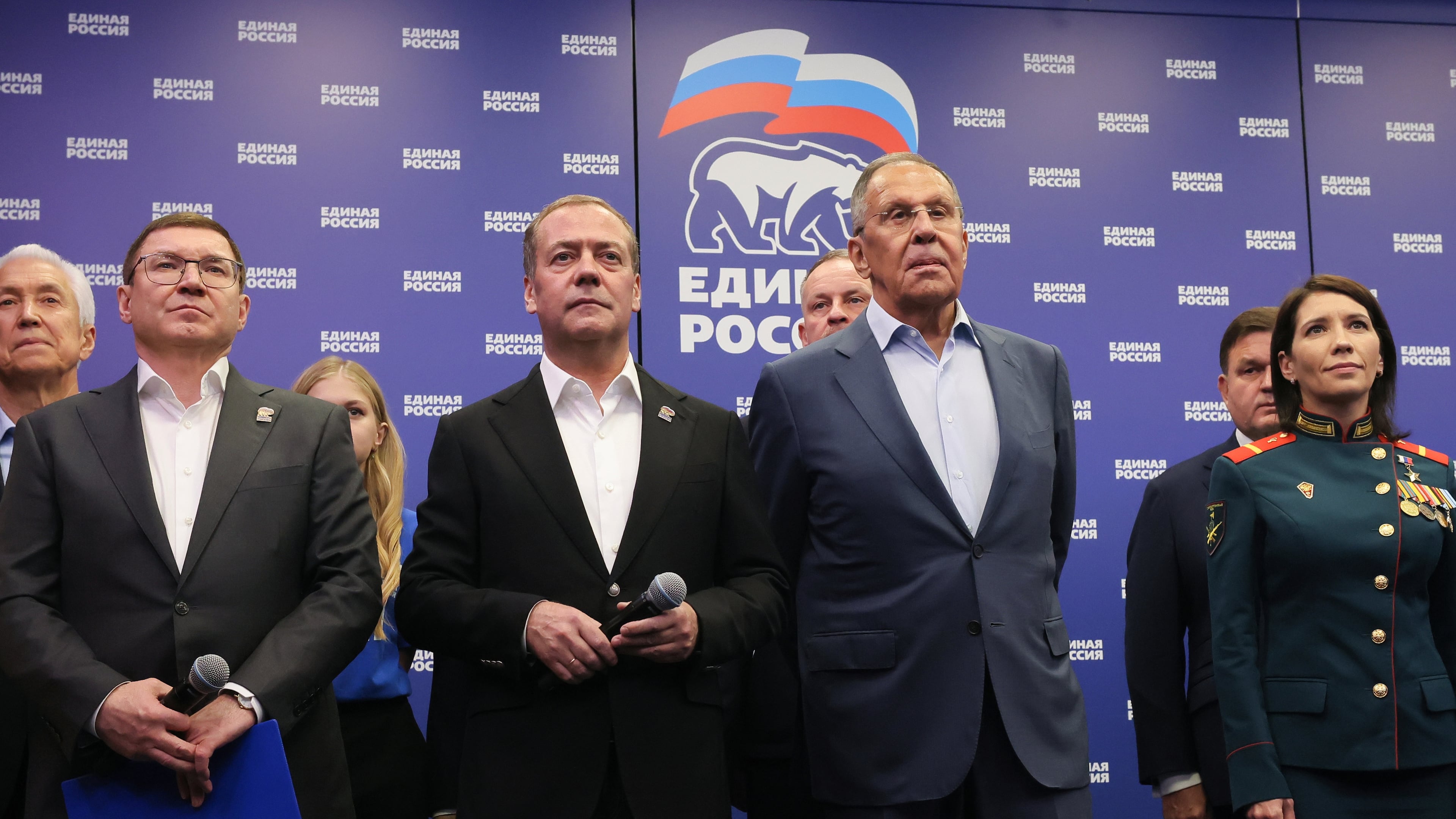 Russian Security Council Deputy Chairman and the head of the United Russia party Dmitry Medvedev, center, and Russian Foreign Minister Sergey Lavrov, center right, stand with other party members as they watch preliminary voting results for Russian parliamentary elections at the United Russia's headquarters in Moscow, Russia, Sunday, Sept. 20, 2026. (Ekaterina Shtukina, Sputnik, Kremlin Pool Photo via AP)