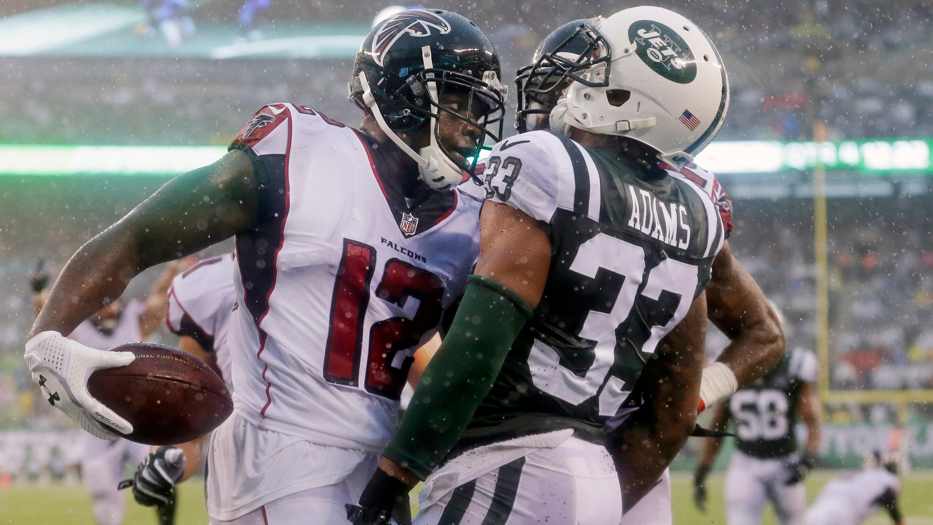 Atlanta Falcons wide receiver Mohamed Sanu (12) exchanges words with New York Jets' Jamal Adams (33) after catching a pass for a touchdown during the second half of an NFL football game in the rain Sunday, Oct. 29, 2017, in East Rutherford, N.J. (AP Photo/Seth Wenig)