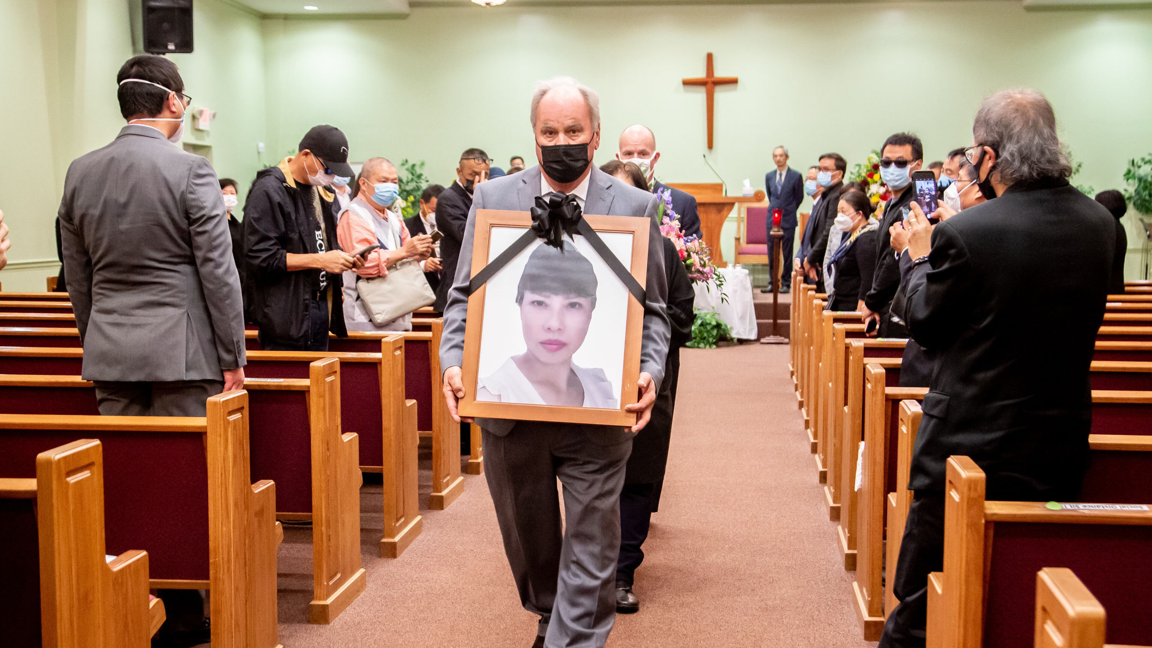 A photograph of Daoyou Feng is carried out of Lee's Funeral Home after her funeral in Norcross on April 4. The 44-year-old was among the eight people slain in metro Atlanta spa shootings last month. (Photo: Steve Schaefer for The Atlanta Journal-Constitution)