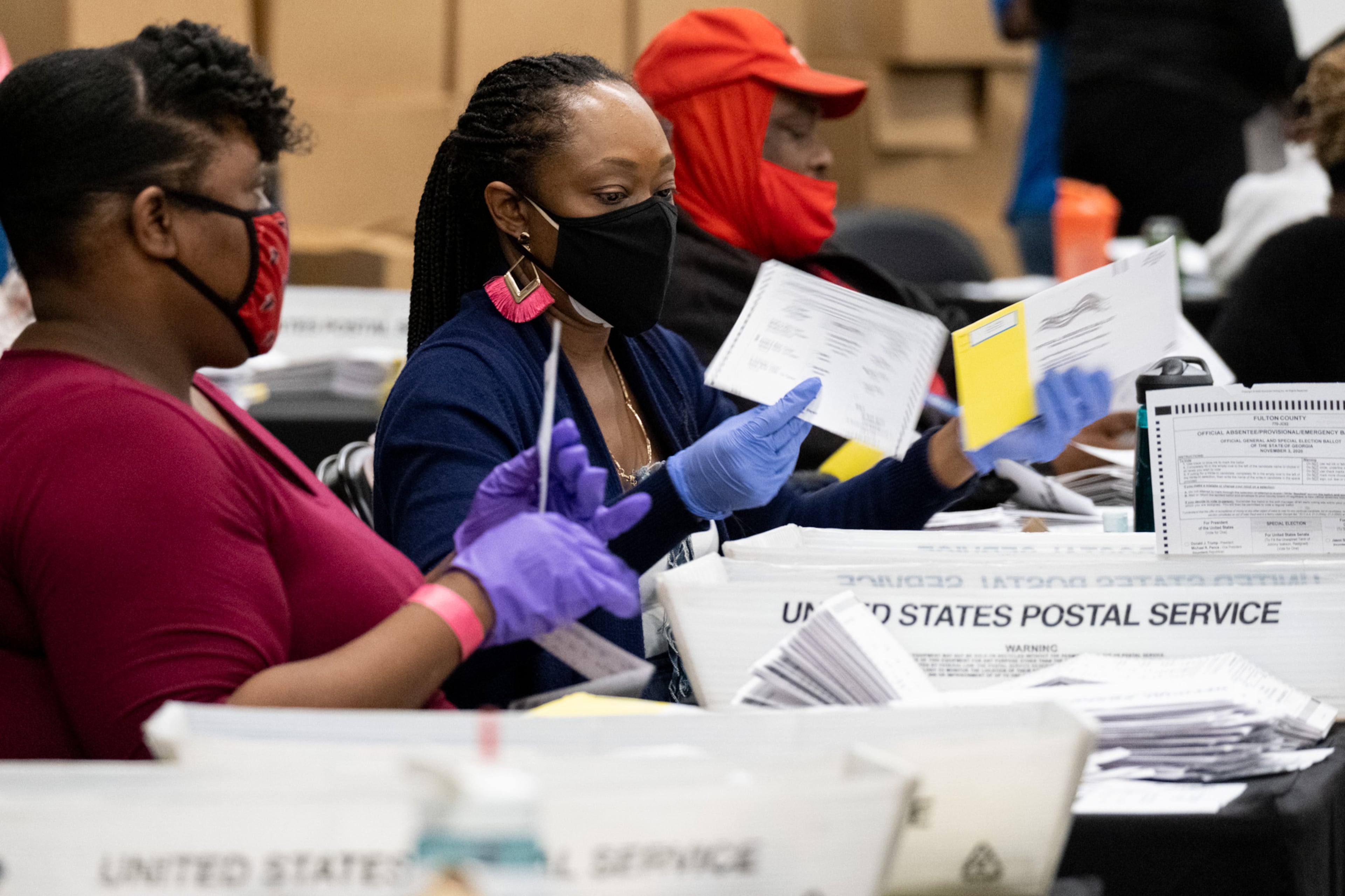 201103-Atlanta-Workers sort mail-in and drop-off ballots at the Fulton County sorting center at State Farm Arena on Tuesday evening Nov. 3, 2020 just before polls closed. Ben Gray for the Atlanta Journal-Constitution