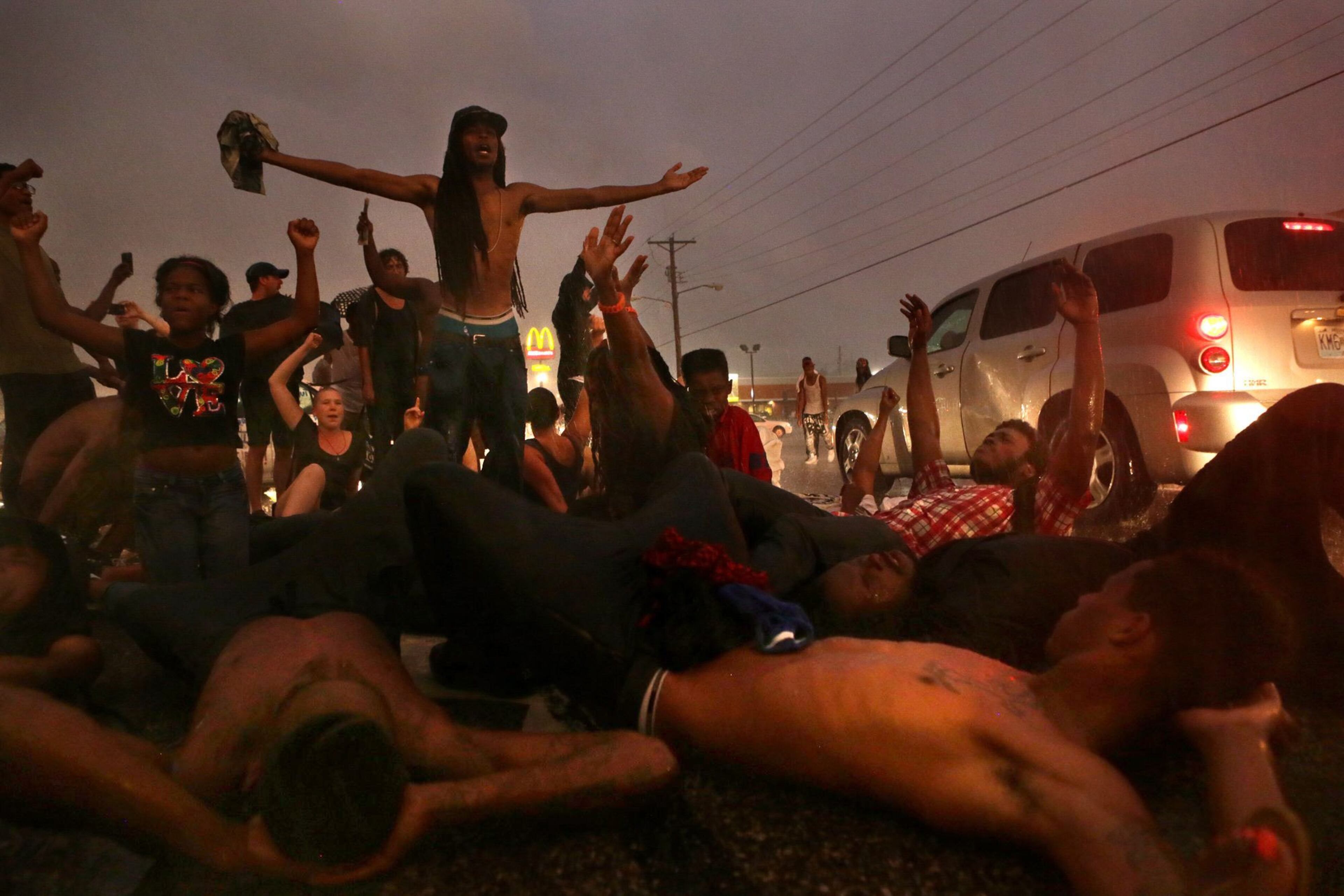 People protest on West Florissant Ave., Sunday, Aug. 9, 2015, in Ferguson, Mo., on the one-year anniversary of Michael Brown being shot and killed by Ferguson Police Officer Darren Wilson. (Cristina M. Fletes/St. Louis Post-Dispatch via AP) EDWARDSVILLE INTELLIGENCER OUT; THE ALTON TELEGRAPH OUT; MANDATORY CREDIT