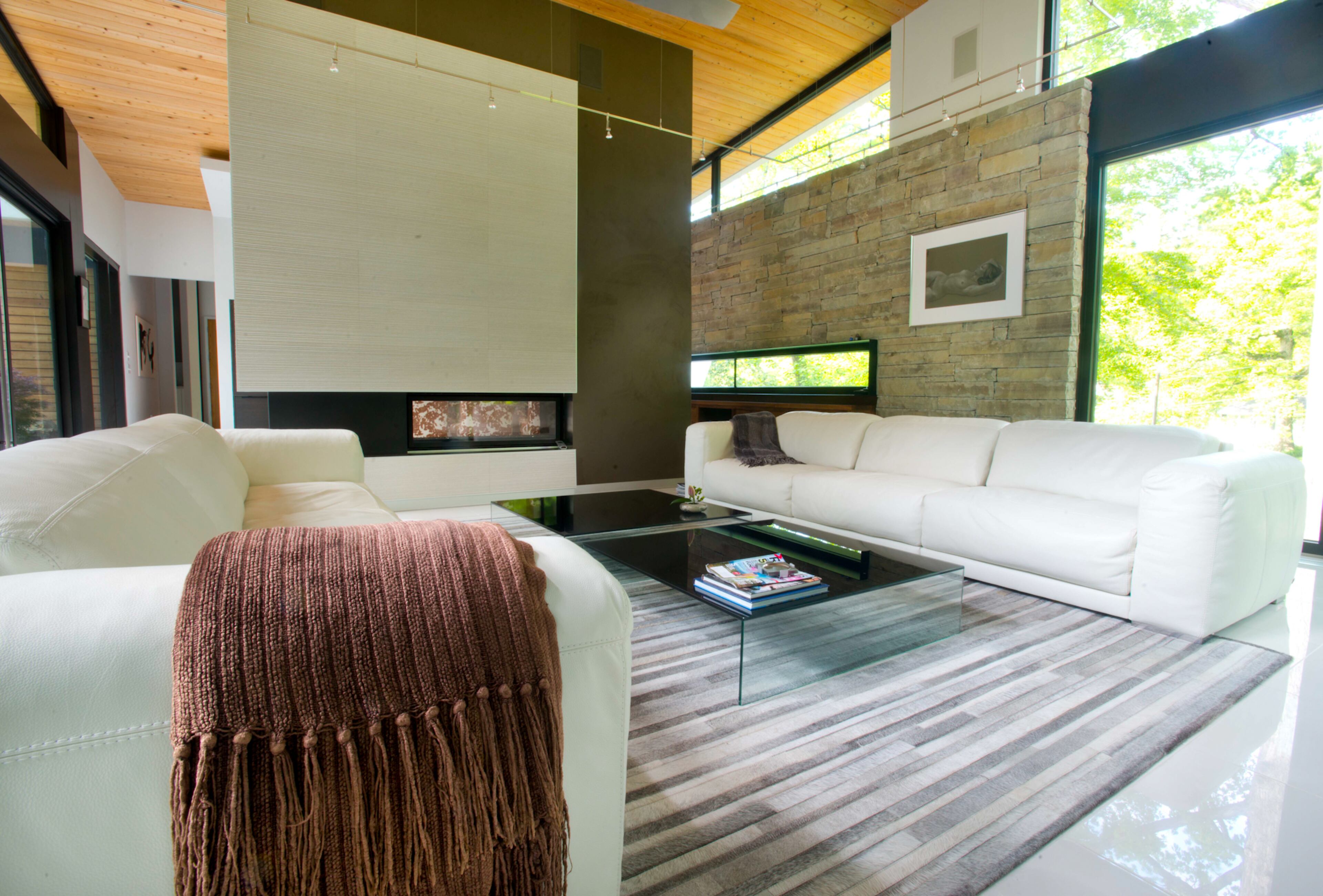 The couple originally was "stumped" about what to do with the fireplace, which originally was left with drywall, Candy said. Since the fireplace is a focal point in the home, they didn't want to do trial and error with the materials. Designer Burns Century found the gray grooved ceramic tile from Porcelanosa and suede wall covering for the fireplace.