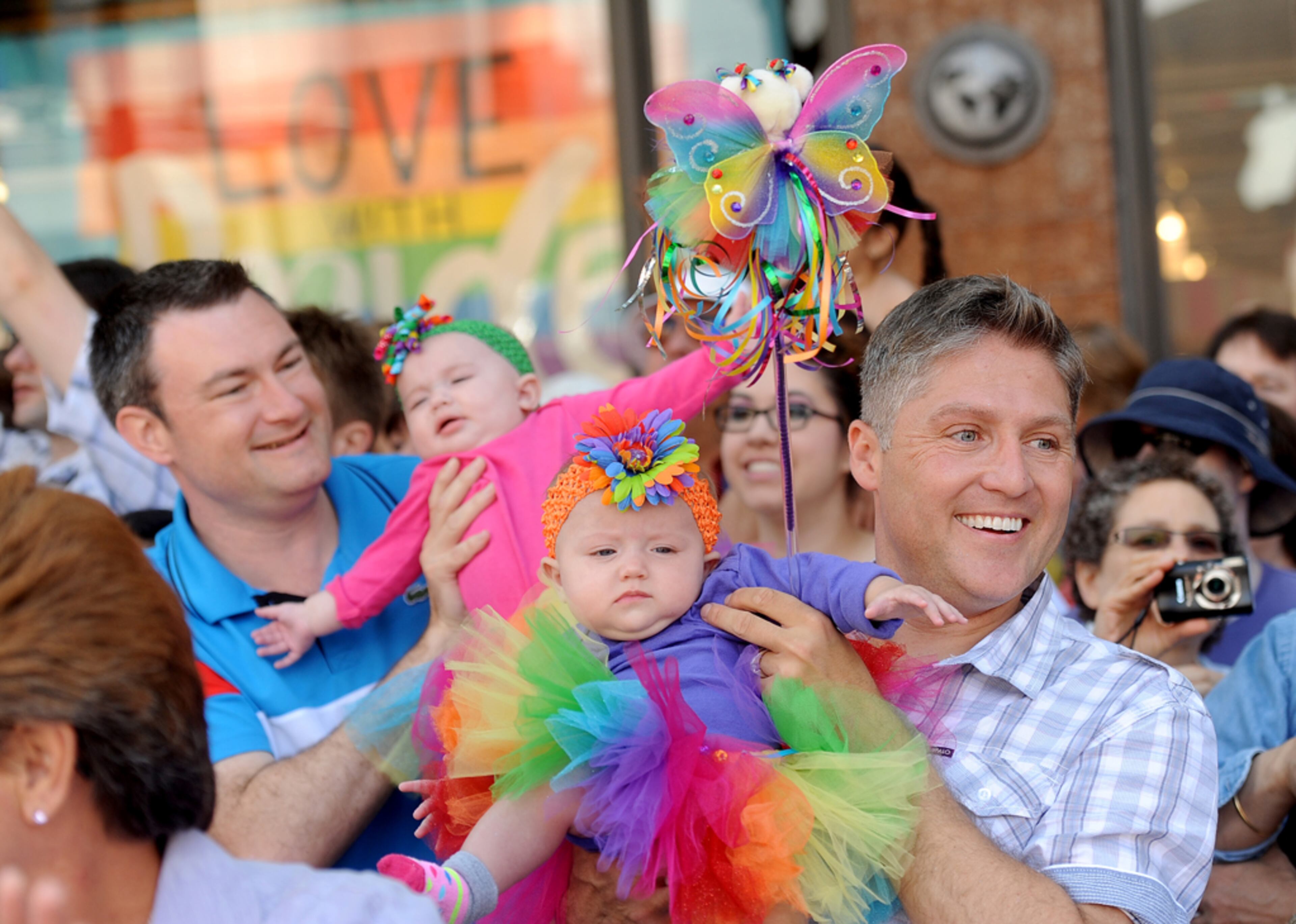 Tim, right, and Joseph Ginejko hold their 6-month-old twin daughters while watching San Francisco's 43rd annual Gay Pride parade Sunday, June 30, 2013. The couple, who traveled from Fresno, Calif. for the celebration, wed in 2008. (AP Photo/Noah Berger)
