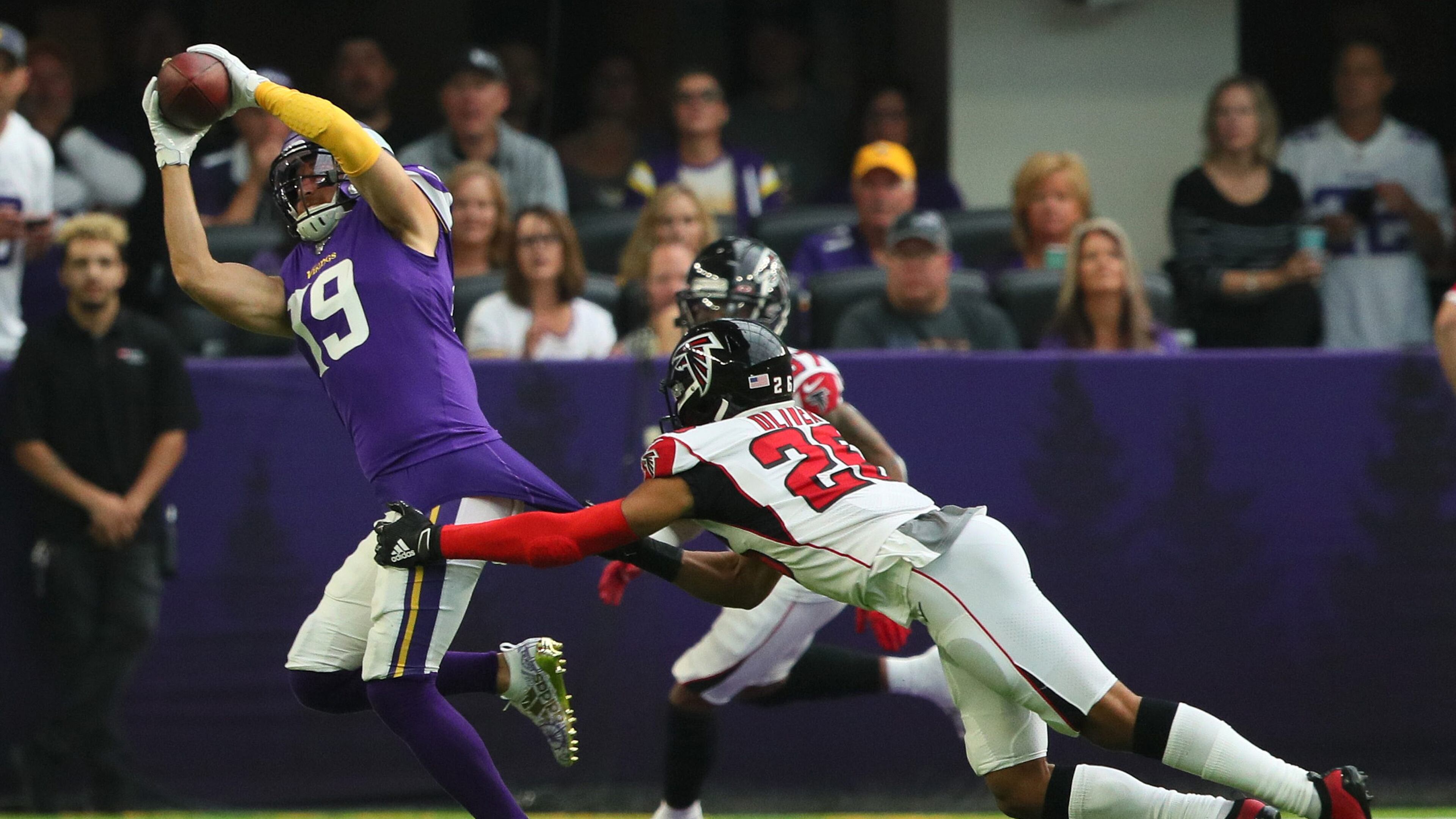 MINNEAPOLIS, MN - SEPTEMBER 08: Adam Thielen #19 of the Minnesota Vikings pulls in a pass for a 23 yard touchdown while Isaiah Oliver #26 of the Atlanta Falcons attempt the tackle in the first quarter at U.S. Bank Stadium on September 8, 2019 in Minneapolis, Minnesota. (Photo by Adam Bettcher/Getty Images)