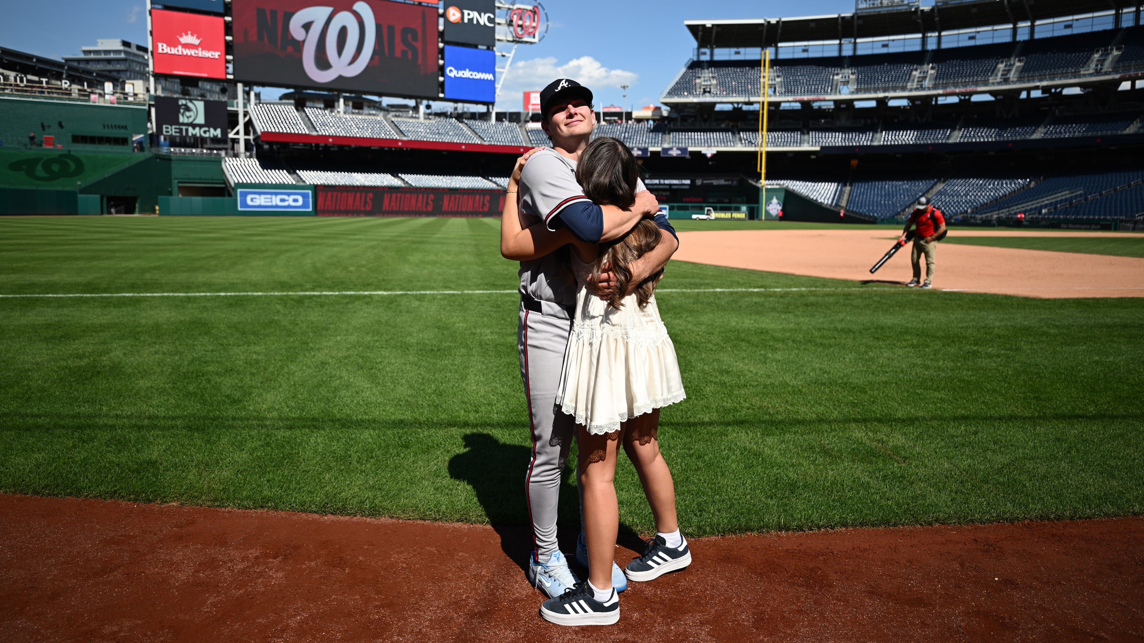 Atlanta Braves starting pitcher JR Ritchie, back, hugs his fiancée Makena Miller after winning his major league debut baseball game against the Washington Nationals, Thursday, April 23, 2026, in Washington. (AP Photo/Nick Wass)