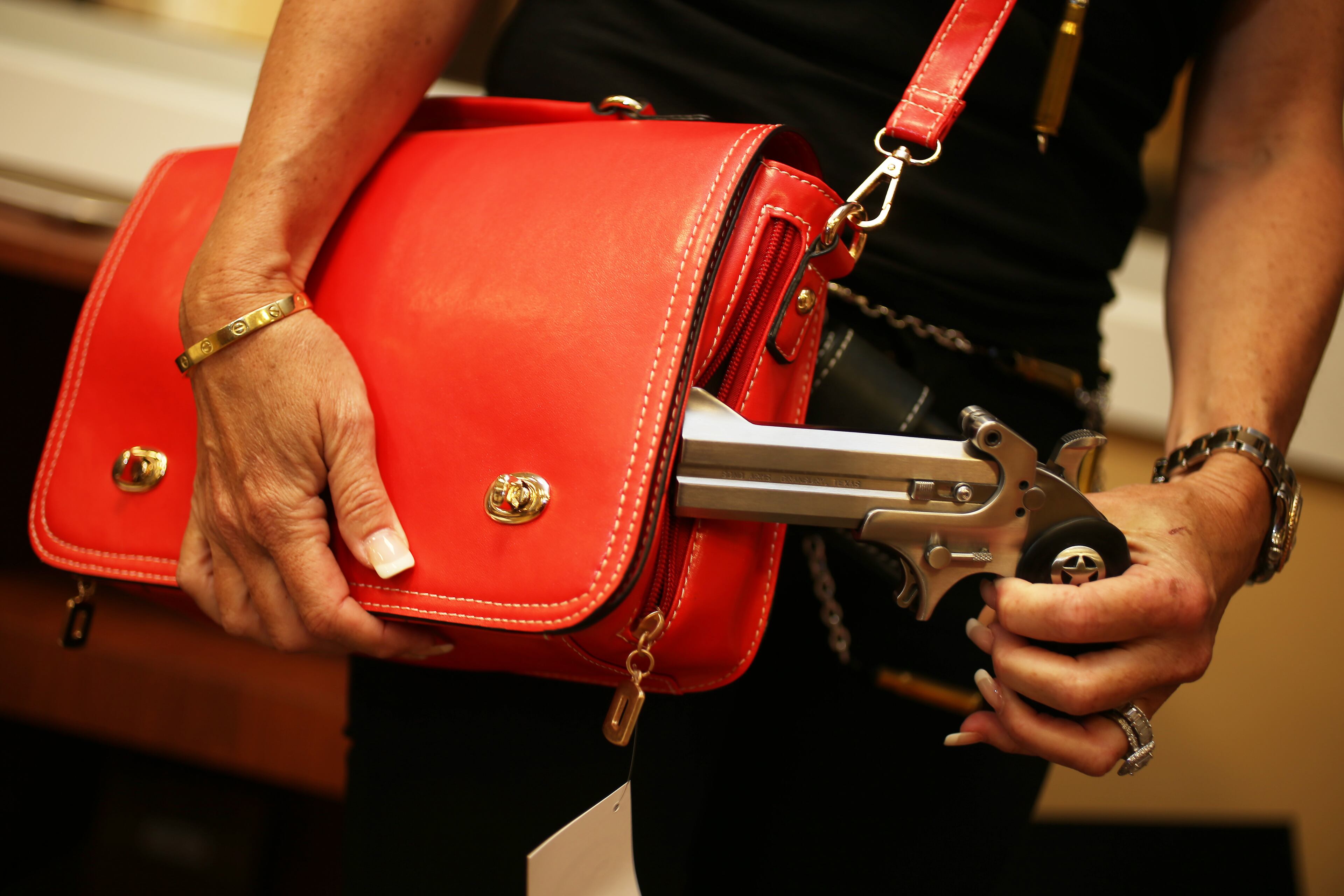 Susan Kushlin poses with a concealed-carry handbag from Gun Girls Inc.