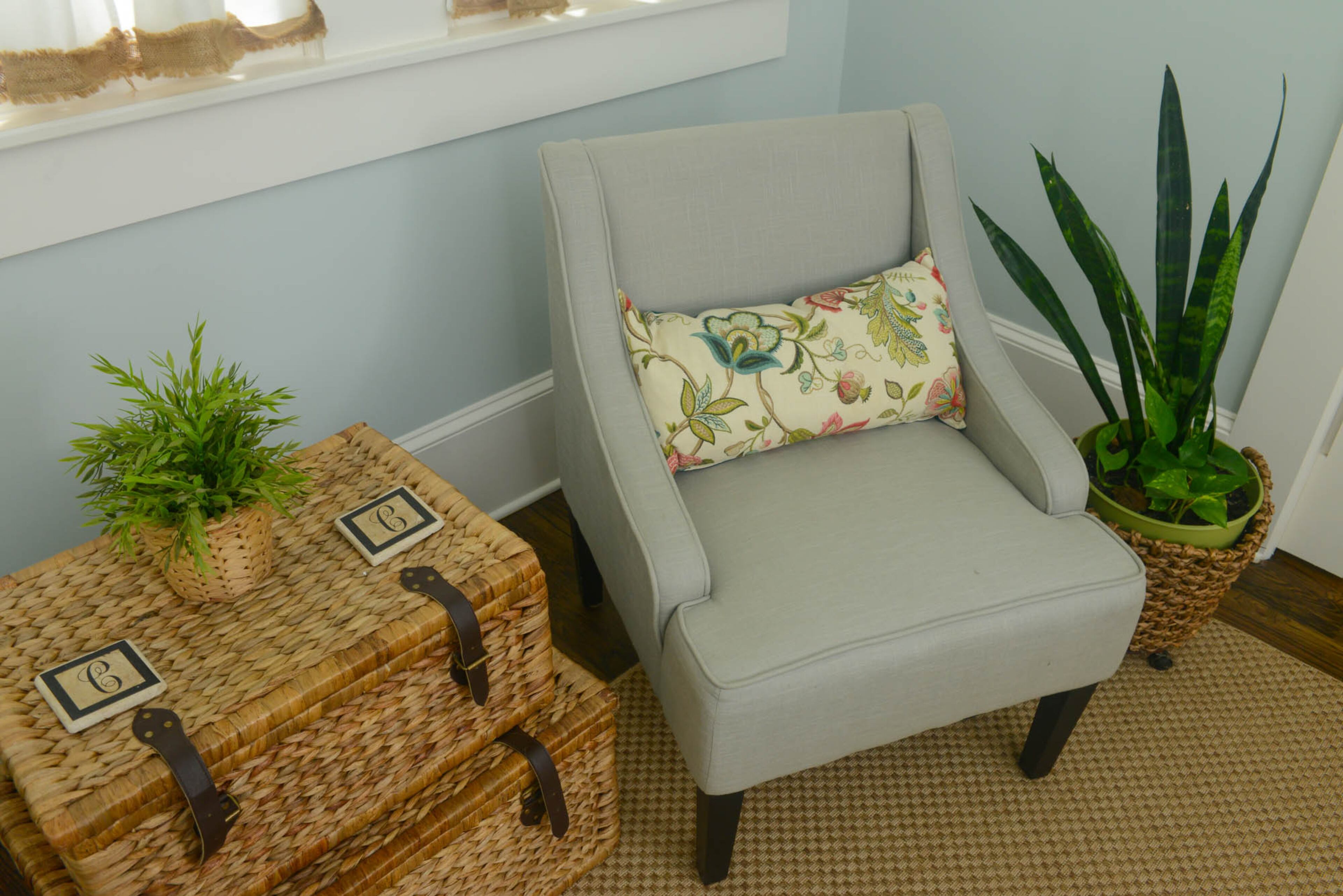 A natural fiber rug, woven baskets, live plants and botanical prints offer organic texture and natural color against the sky-blue background of the home office walls.