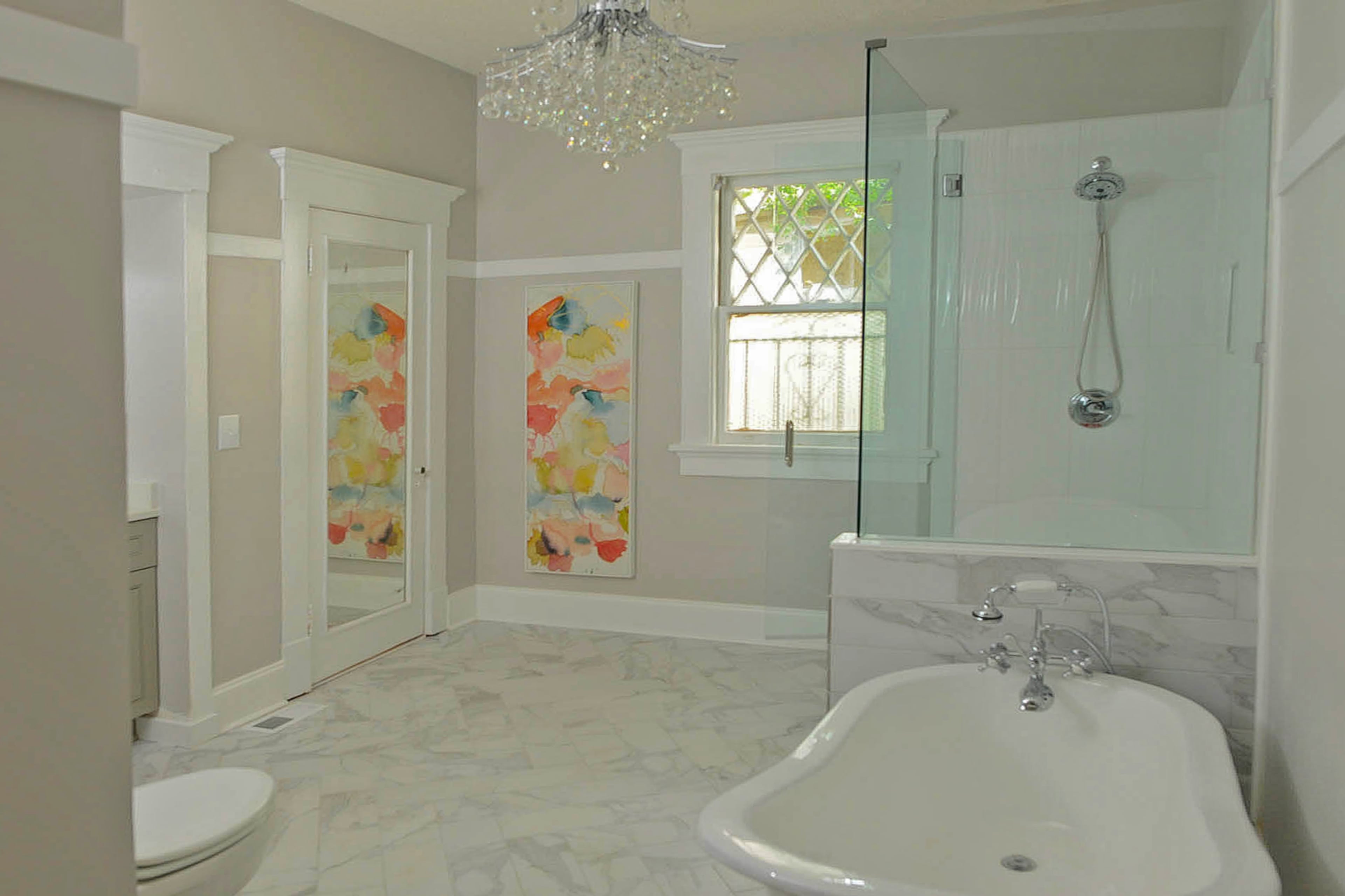 Brenda Hubbard's newly renovated bathroom features a standalone tub from The Tub Connection and a crystal chandelier.