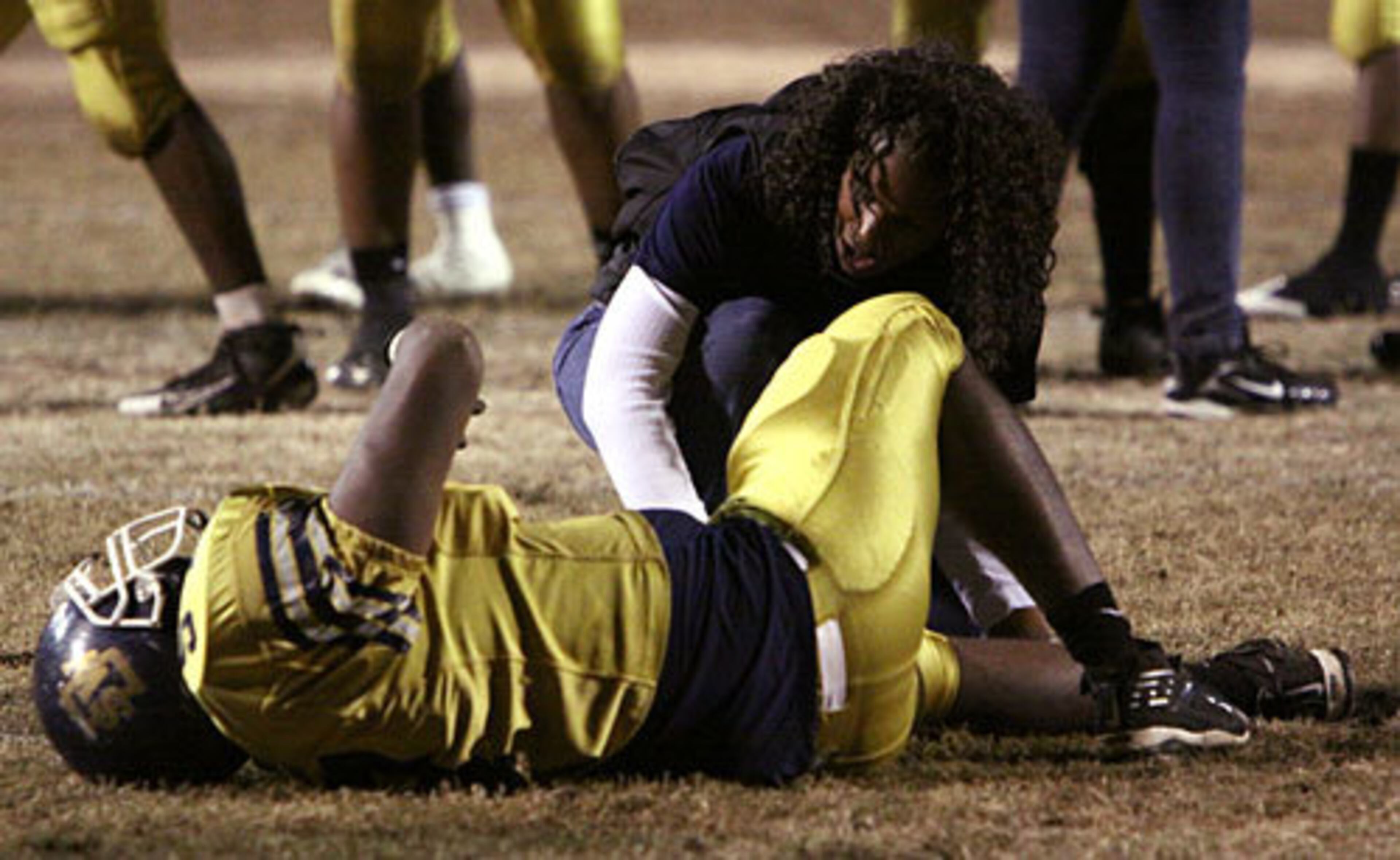 Southwest DeKalb's Javon Davis lies on the 10-yard line after falling injured after the preceding play.