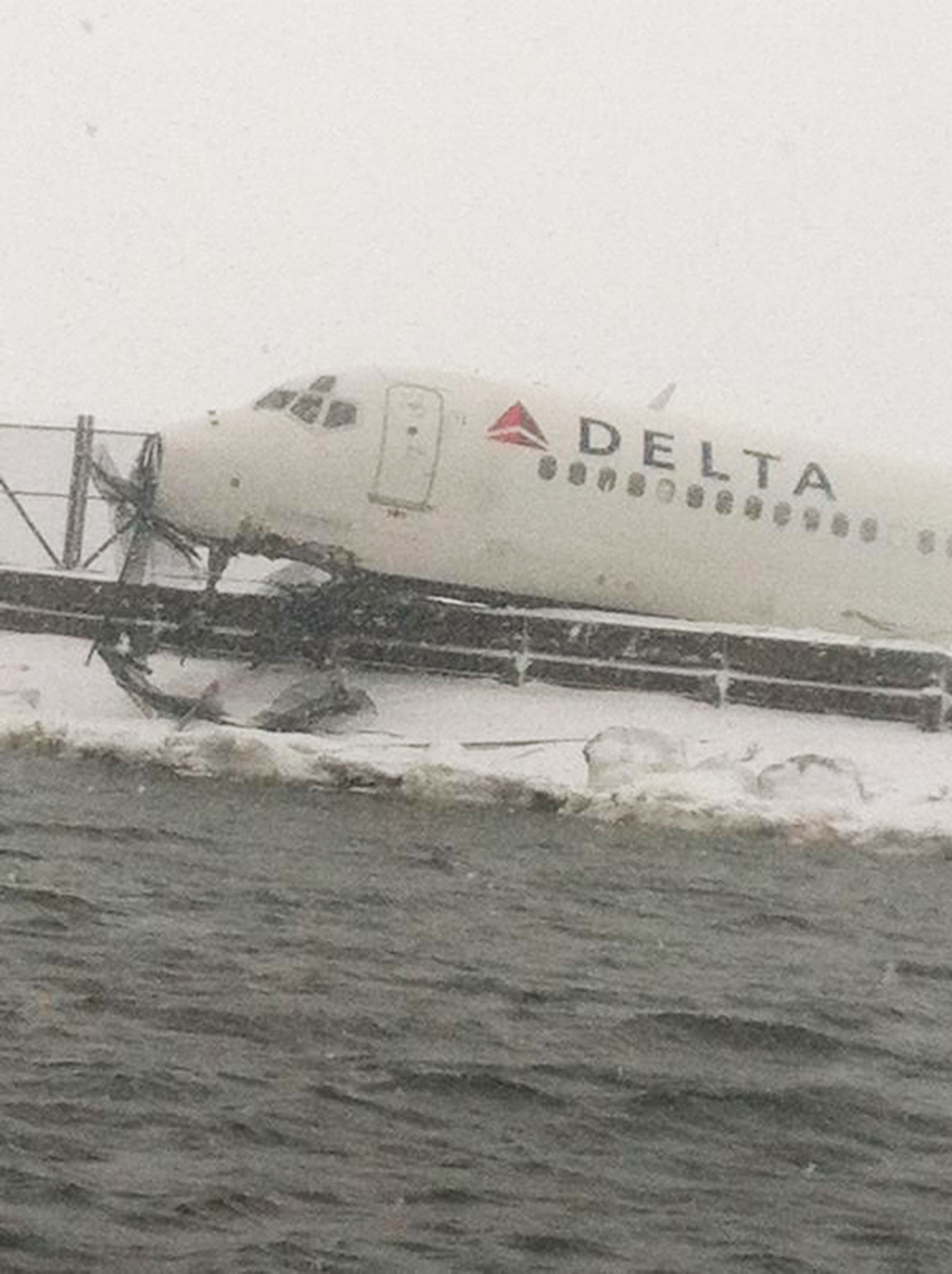 NEW YORK, NY - MARCH 5: In this handout from the New York City Fire Department (FDNY), A Delta Air Lines jetliner rests on a berm at LaGuardia Airport March 5, 2015 in Queens, New York City. Delta flight 1086, flying to New York from Atlanta, reportedly skidded off the runway after it landed during a snowstorm. (Photo by New York City Fire Department (FDNY) via Getty Images)