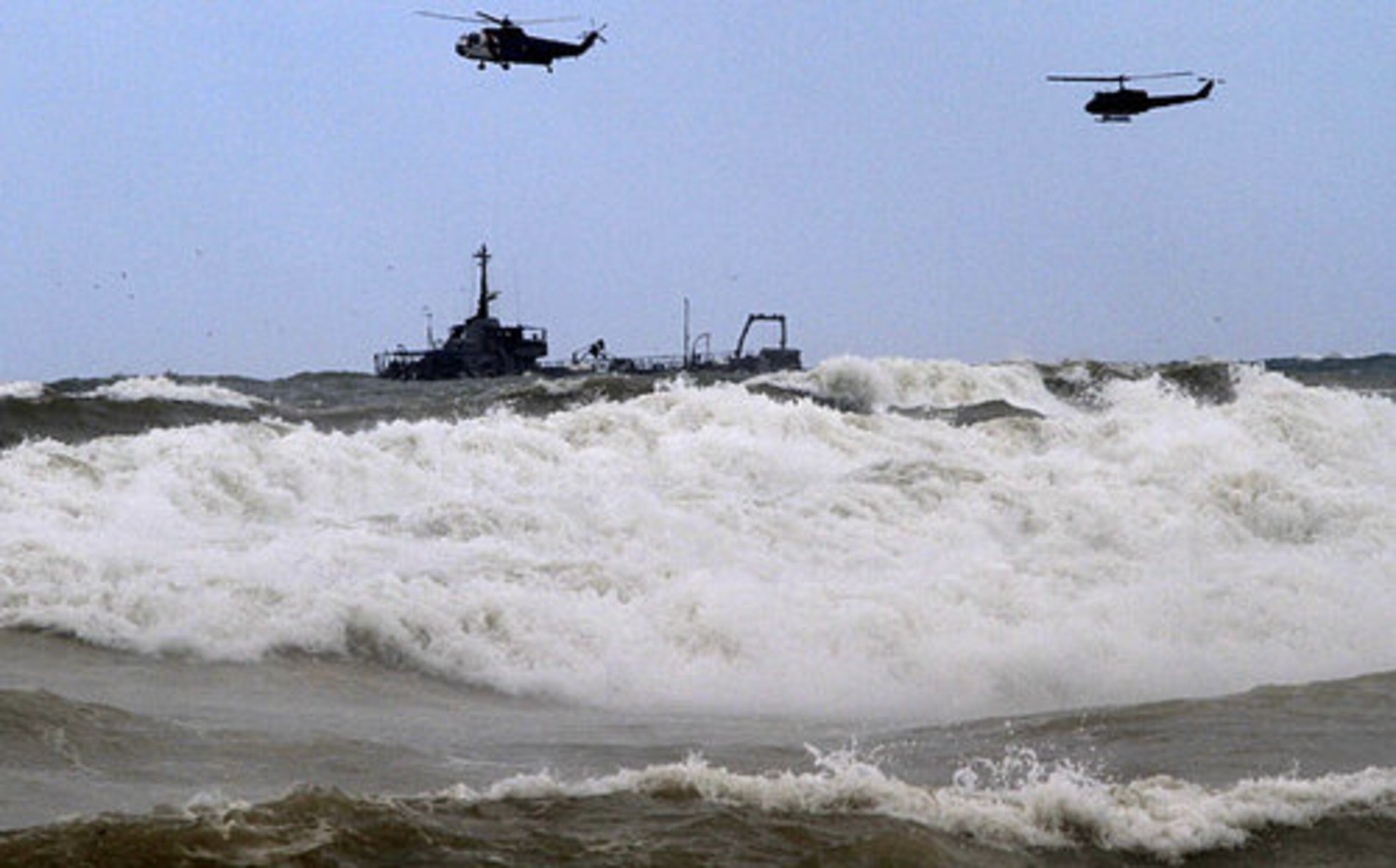A Lebanese vessel and helicopters search for survivors from the Ethiopian Airlines plane that crashed in the sea in Khalde, south of Beirut, Lebanon, Monday, Jan. 25, 2010.