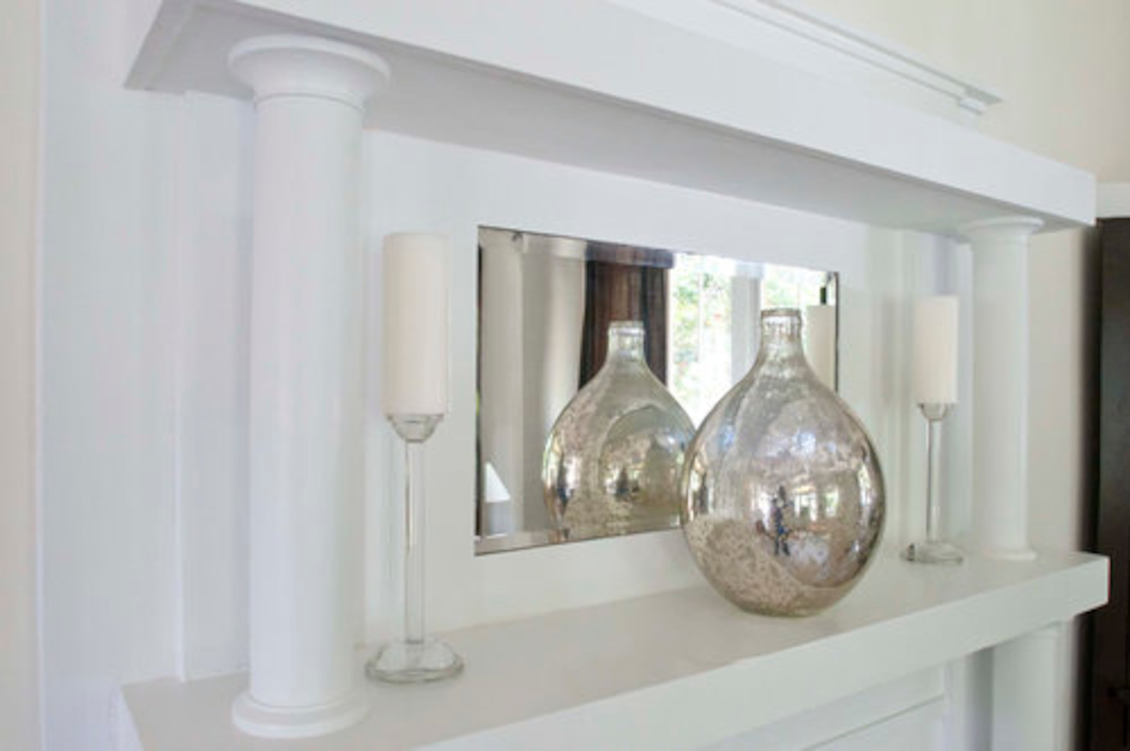 A mercury glass vase on the mantel in the living room adds sparkle to the space.