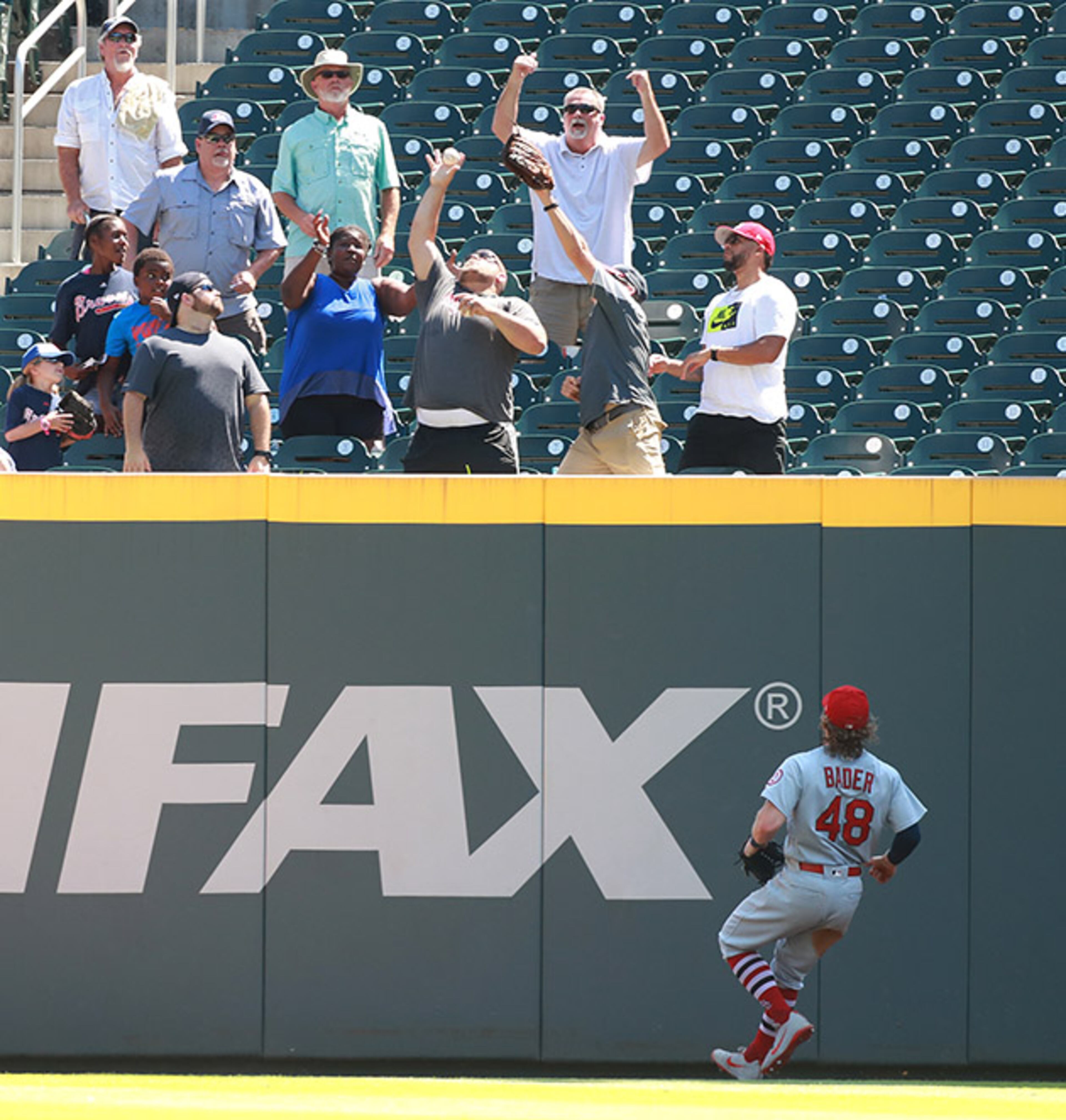 St. Louis Cardinals outfielder Harrison Badder looks on as a baseball fan catches Atlanta Braves Freddie Freeman's 2-run homer for a 2-0 lead over the Cardinals during the fourth inning Wednesday, Sept. 19, 2018, at SunTrust Park in Atlanta.