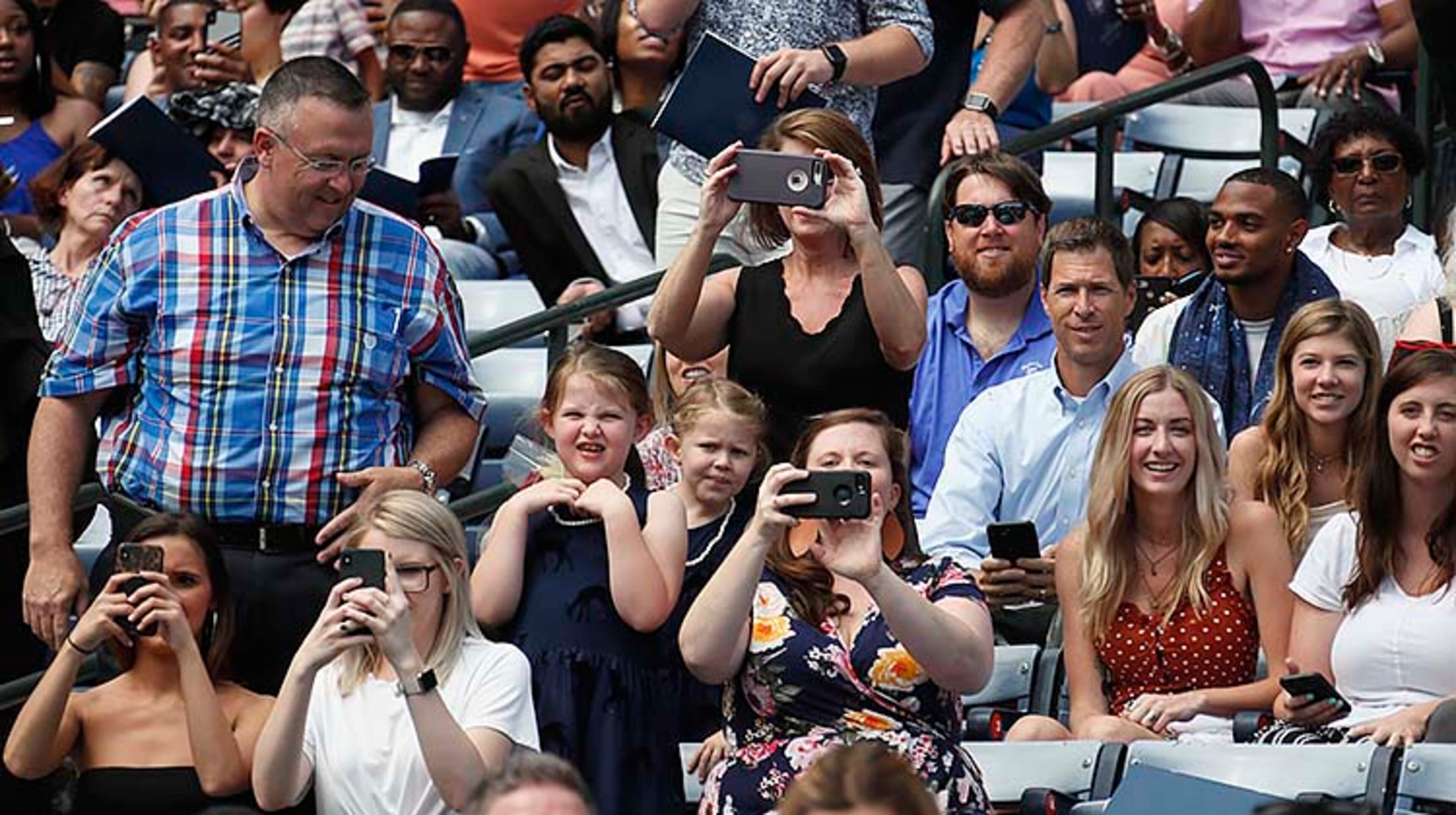 May 9, 2019 - Atlanta - Family members cheer and strain for a look as their graduates name is called to take the stage. Georgia State University is hosting its 104th Commencement Monday, May 6 through Tuesday, May 14 at Panther Stadium in Atlanta. Six schools held their graduation on Thursday. Bob Andres / bandres@ajc.com