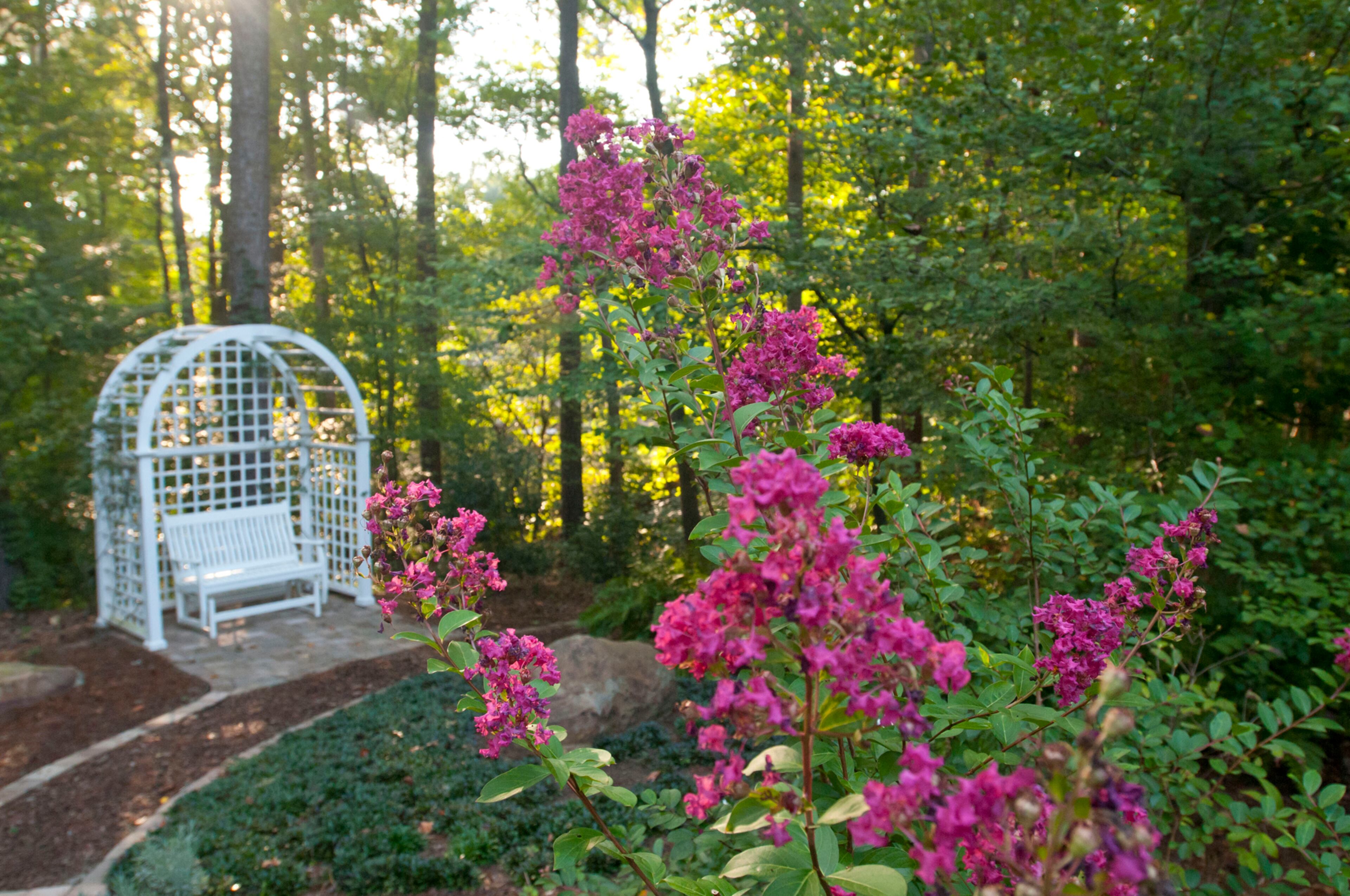 Designing the garden: The couple took trips to other gardens to get ideas and even plans for their garden. At Longwood Gardens in Pennsylvania, the architects shared their trellis design, which the Pinckneys used for a custom-made curved arbor trellis with a seating area within the woodland garden.