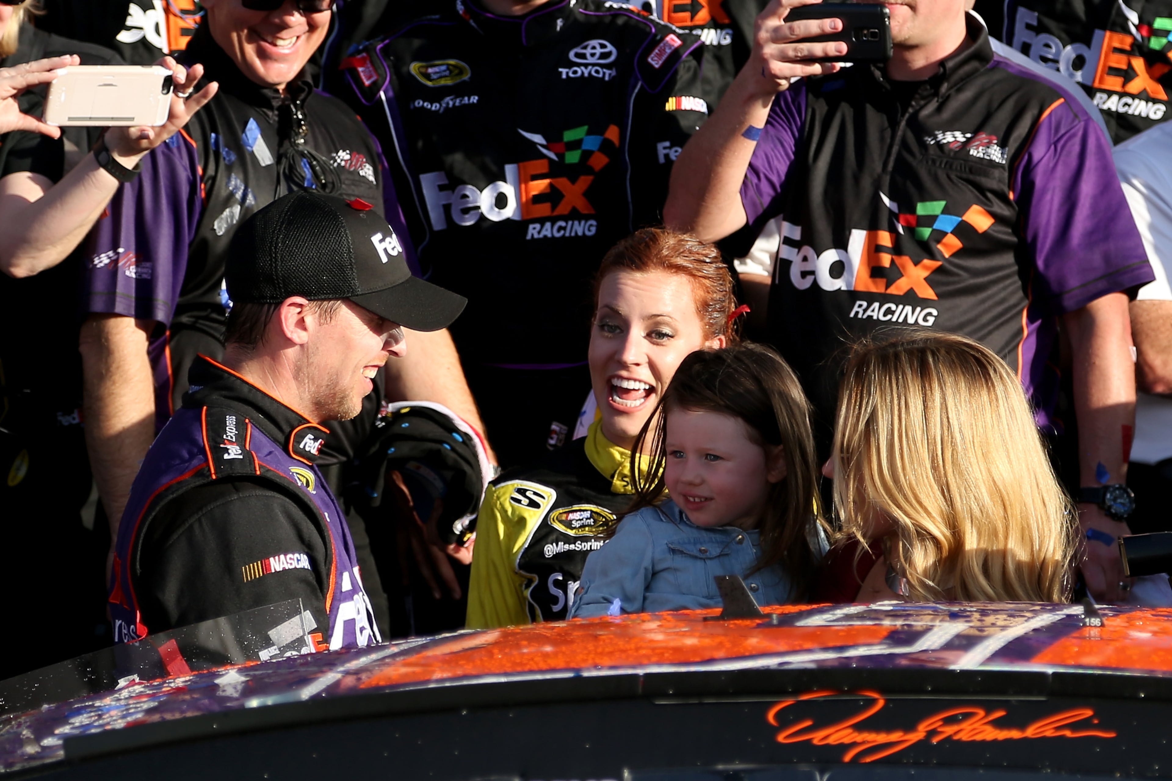 Denny Hamlin, driver of the #11 FedEx Express Toyota, celebrates in Victory Lane with his wife, Jordan Fish, and daughter, Taylor, after winning the NASCAR Sprint Cup Series DAYTONA 500 at Daytona International Speedway on February 21, 2016 in Daytona Beach, Florida. (Photo by Matt Sullivan/Getty Images)