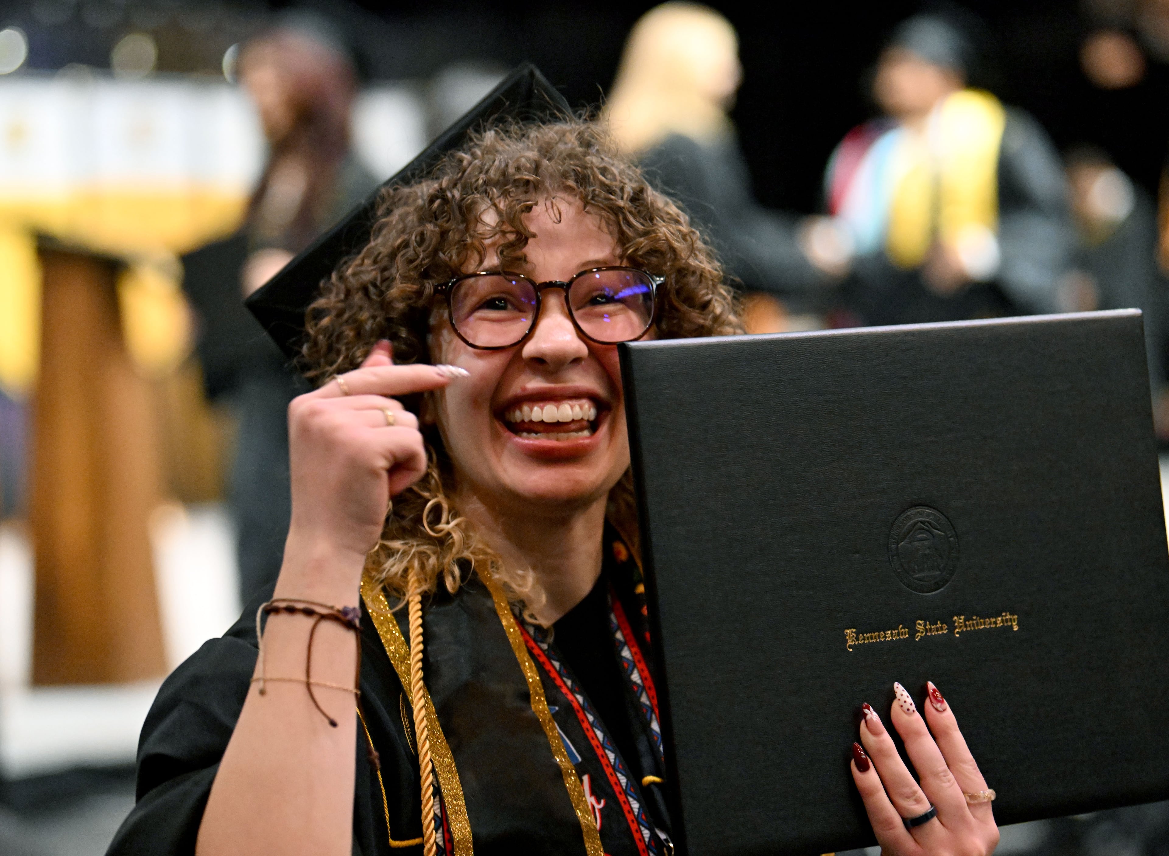 A Kennesaw State graduate is all smiles after receiving her diploma during the niversity’s 2026 sping commencement May 13, 2026. Wednesday's ceremony included the College of Architecture and Construction Management, and the Michael J. Coles College of Business (undergraduate students in entrepreneurship, hospitality, management, marketing and professional sales). (Hyosub Shin/AJC)