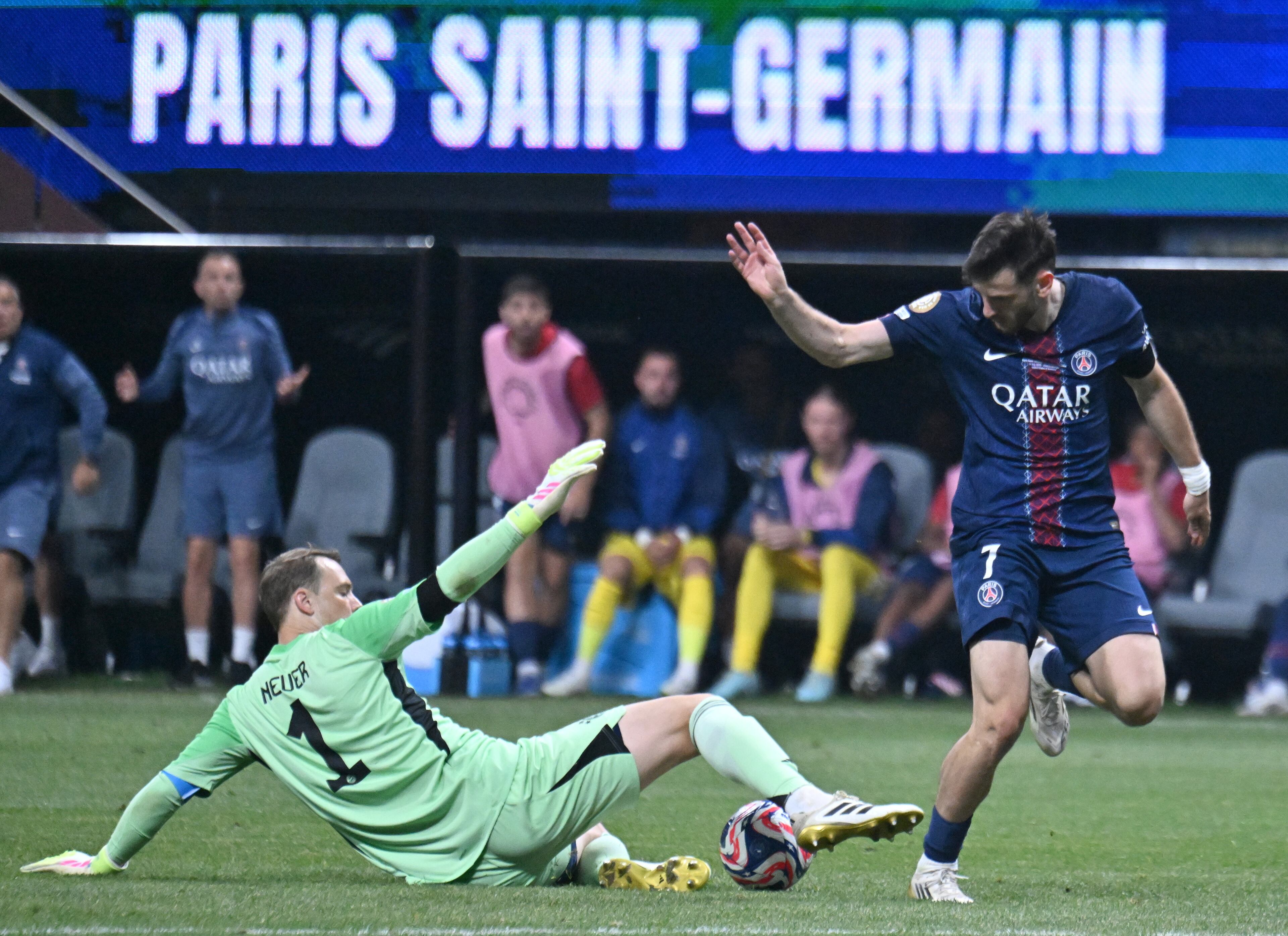Bayern Munich goalkeeper Manuel Neuer (1) stops the ball as Paris Saint-Germain forward Khvicha Kvaratskhelia (7) takes an unsuccessful kick during the second half in Club World Cup quarterfinals match at Mercedes-Benz Stadium, Saturday, July 5, 2025, in Atlanta. Paris Saint-Germain won 2-0 over Bayern Munich. (Hyosub Shin / AJC)