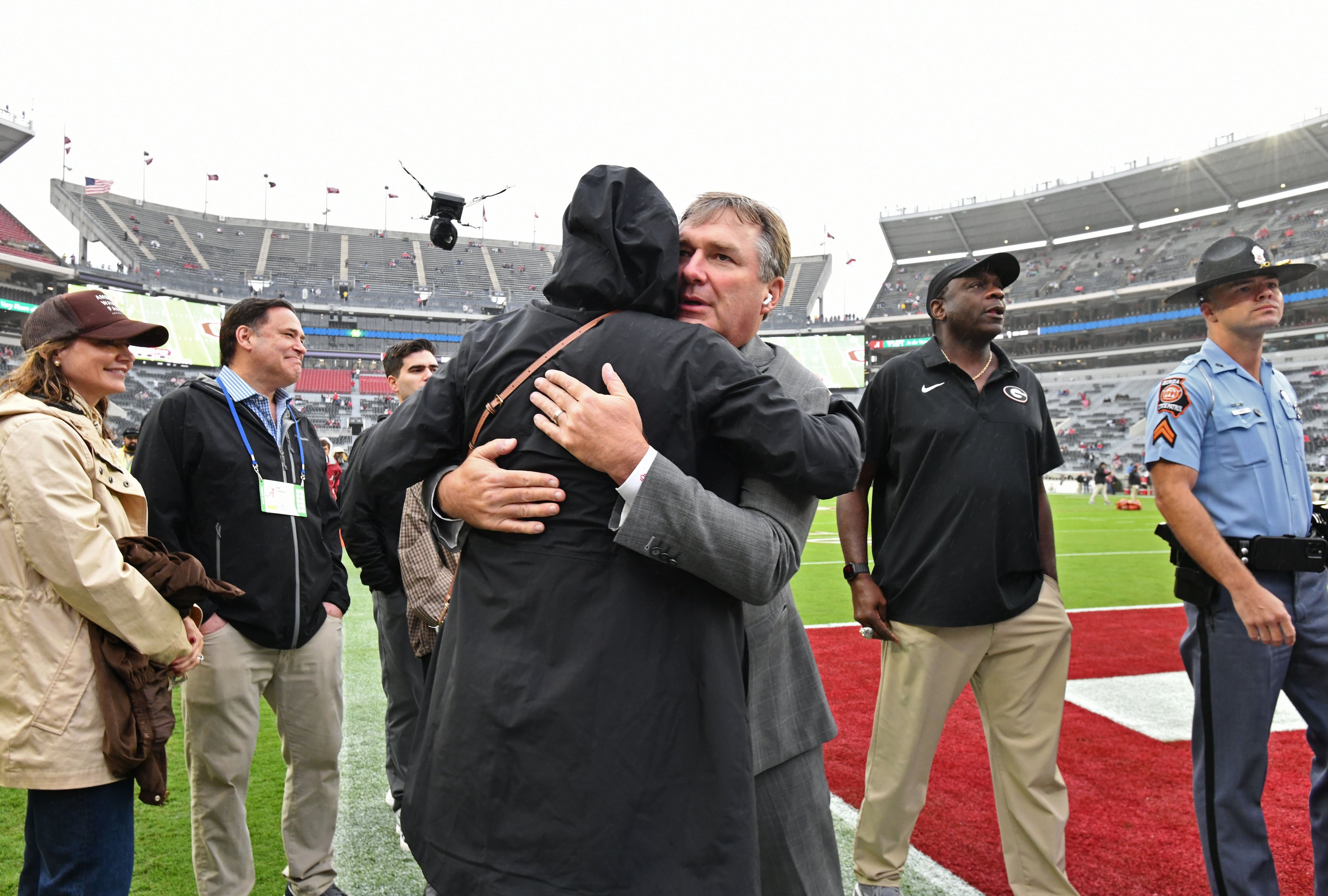 Georgia head coach Kirby Smart hugs his wife Mary Beth as he walks on the field after players and coaching staff arrive before an NCAA football game against Alabama at Bryant-Denny Stadium on Saturday, Oct. 10, 2026, in Tuscaloosa, Alabama. (Hyosub Shin/AJC)