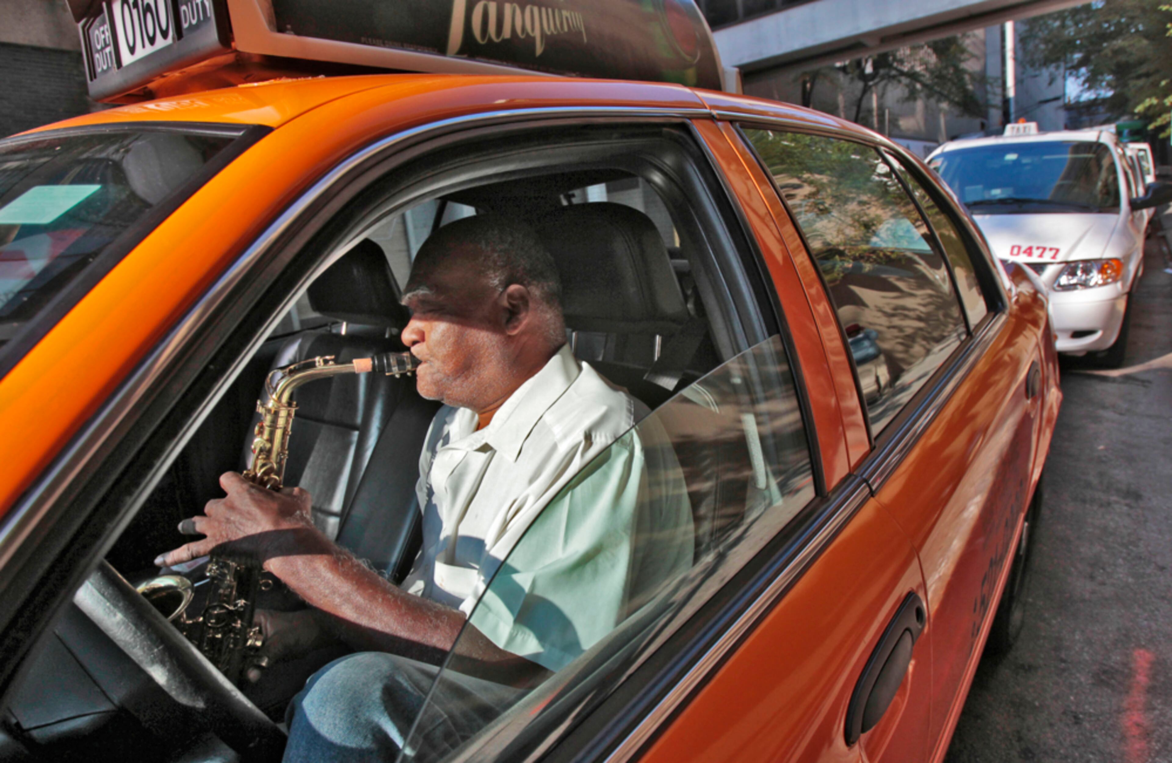 September 25, 2012 - Atlanta - Cab driver George Mallory toots his own horn -- his sax, that it -- as he waits for fares outside the Hyatt Regency downtown. He said he has been playing for 55 years. This is one of my favorite photos of the year. It is one of those moments that brought a smile to my face and to those around him. BOB ANDRES BANDRES@AJC.COM
