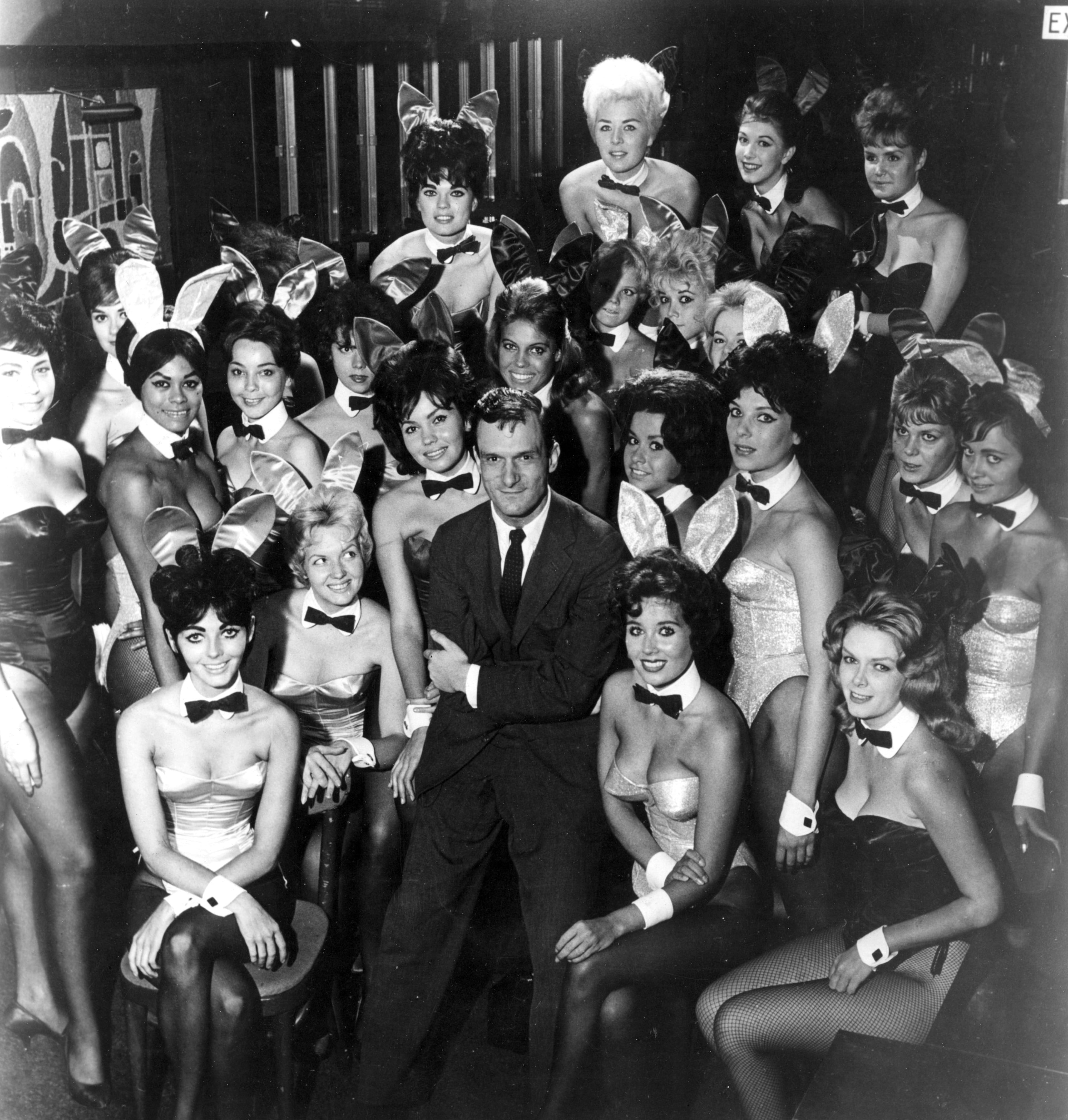 Millionaire publisher of Playboy magazine Hugh Hefner poses with a bevy of bunny girls at one of America's chain of Playboy clubs. (Photo by Helmut Kretz/Getty Images)