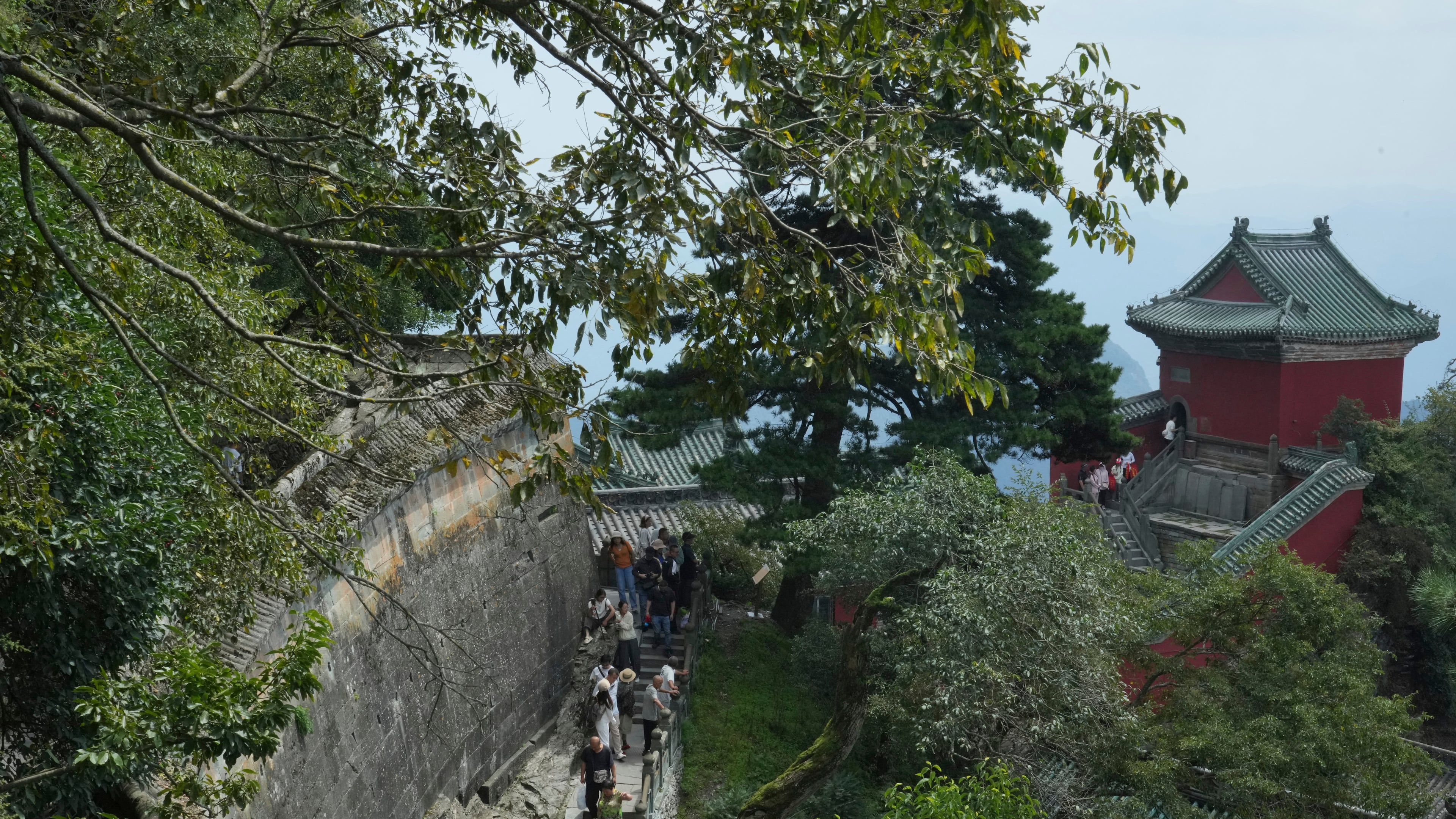 Visitors walk near a temple in Wudang Mountains in central China's Hubei Province on Sept. 3, 2026. (AP Photo/Achmad Ibrahim)