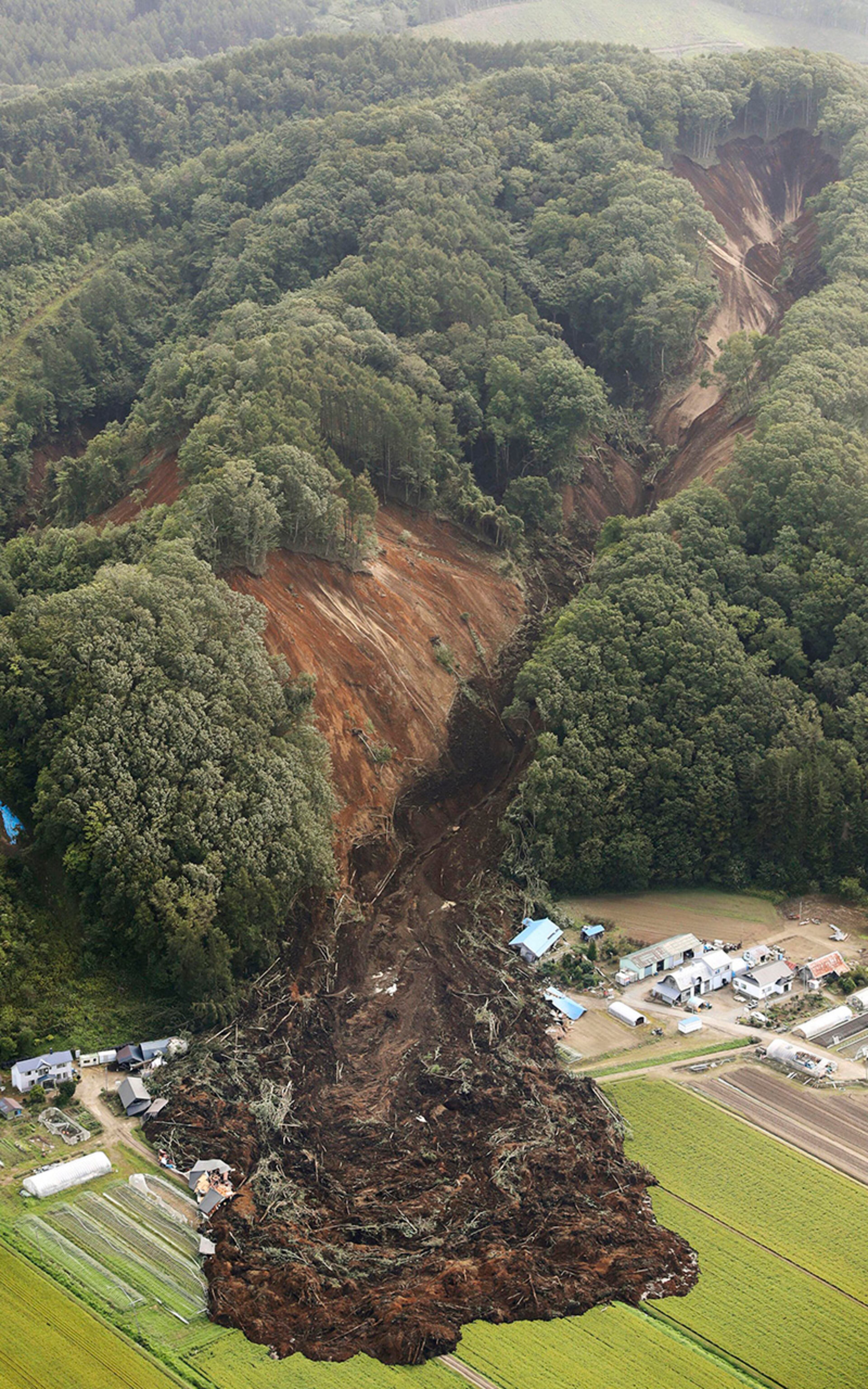 This aerial photo shows the site of a landslide after an earthquake in Atsuma town, Hokkaido, northern Japan, Thursday, Sept. 6, 2018. A powerful earthquake rocked Japanâs northernmost main island of Hokkaido early Thursday, triggering landslides that crushed homes, knocking out power across the island, and forcing a nuclear power plant to switch to a backup generator. (Kyodo News via AP)