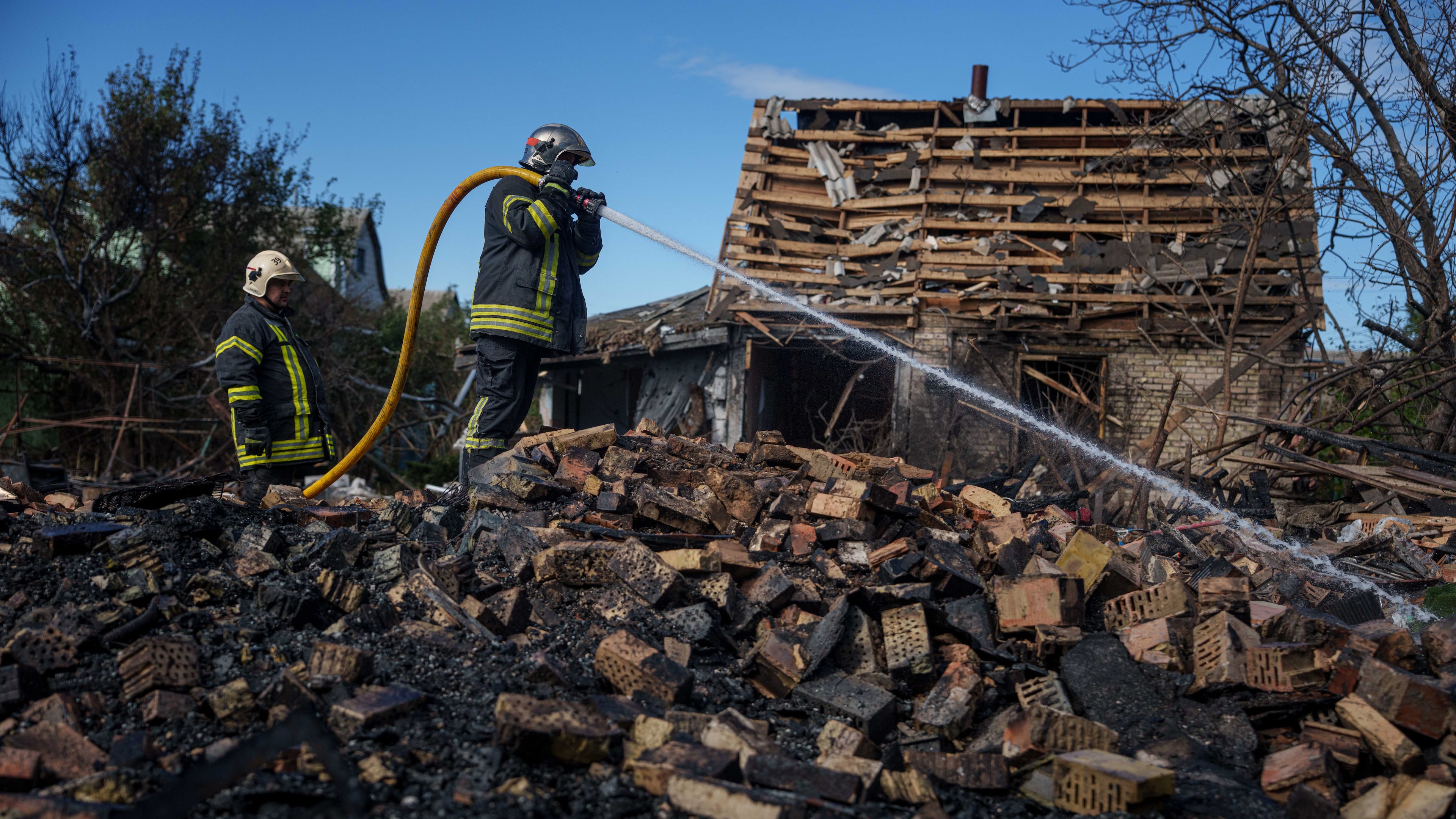 Rescue workers put out a fire at a residential house destroyed in a Russian missile strike on Vyshhorod, Kyiv region, Ukraine, Wednesday, Sept. 30, 2026. (AP Photo/Evgeniy Maloletka)