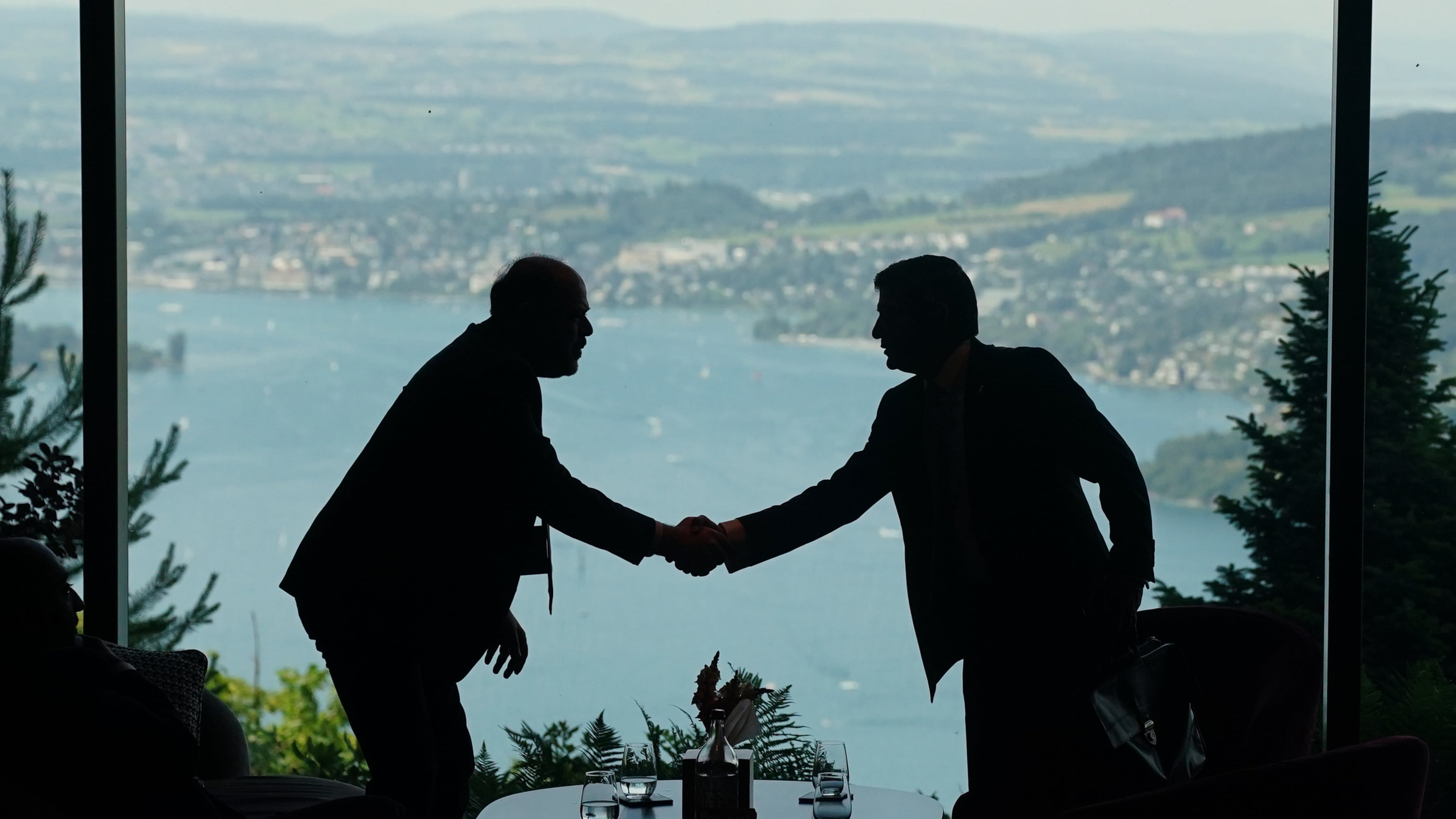 Delegation staff members meet in the lobby on the first day of a quadrilateral meeting between the U.S., Iran, Pakistan, and Qatar at the Buergenstock Resort Lake Lucerne, near Stansstad, Switzerland, Sunday, June 21, 2026. (Nathan Howard/Pool Photo via AP)