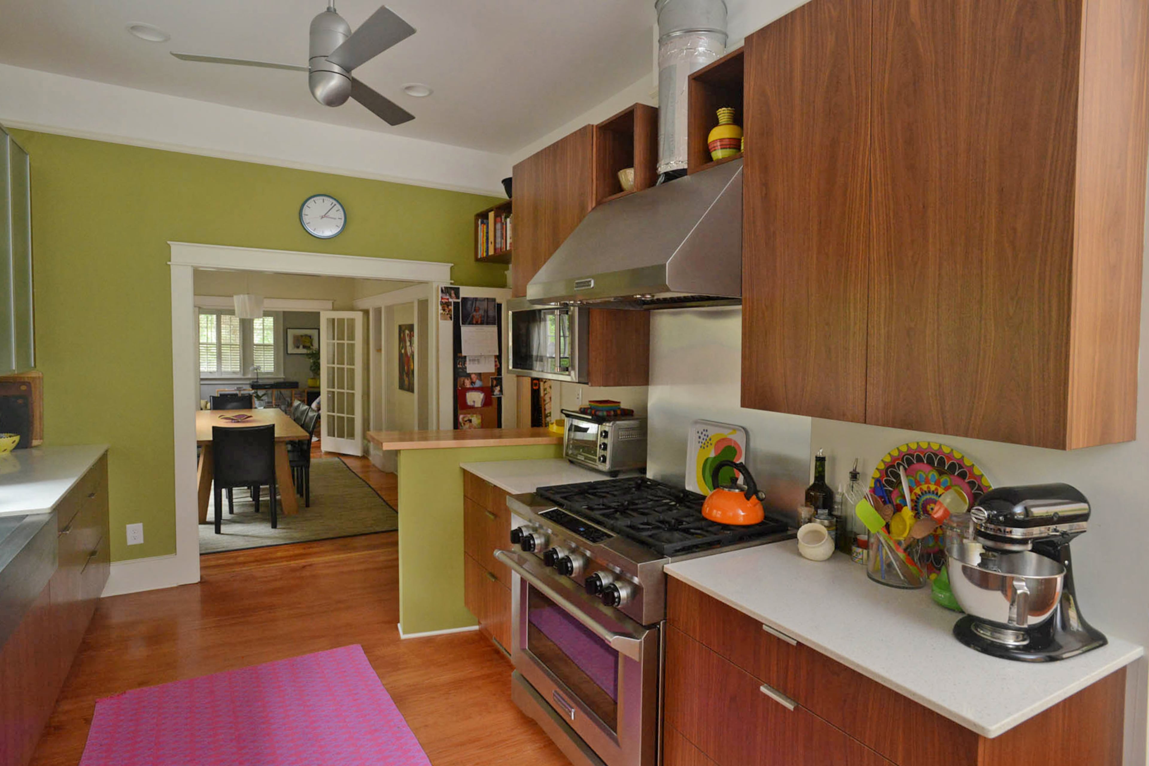 Custom cabinets from And How! Furniture in Tucker and appliances from KitchenAid give the Candler Park kitchen its modern vibe, while green walls echo Karen’s love of decorating with live plants.