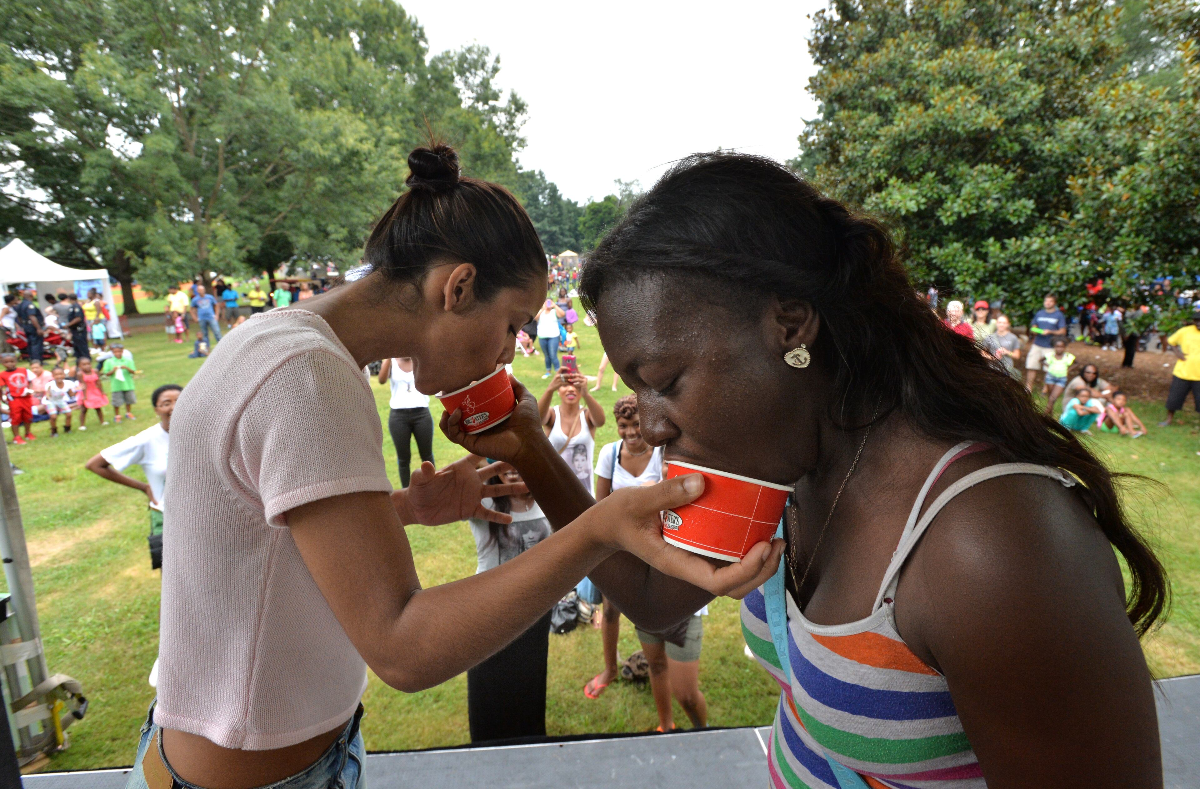 Ashley Jones (left) and Ashley Williams compete in the Ice Cream Eating Competition hosted by Bruster's during the third annual Atlanta Ice Cream Festival at Piedmont Park in Atlanta on July 27, 2013.