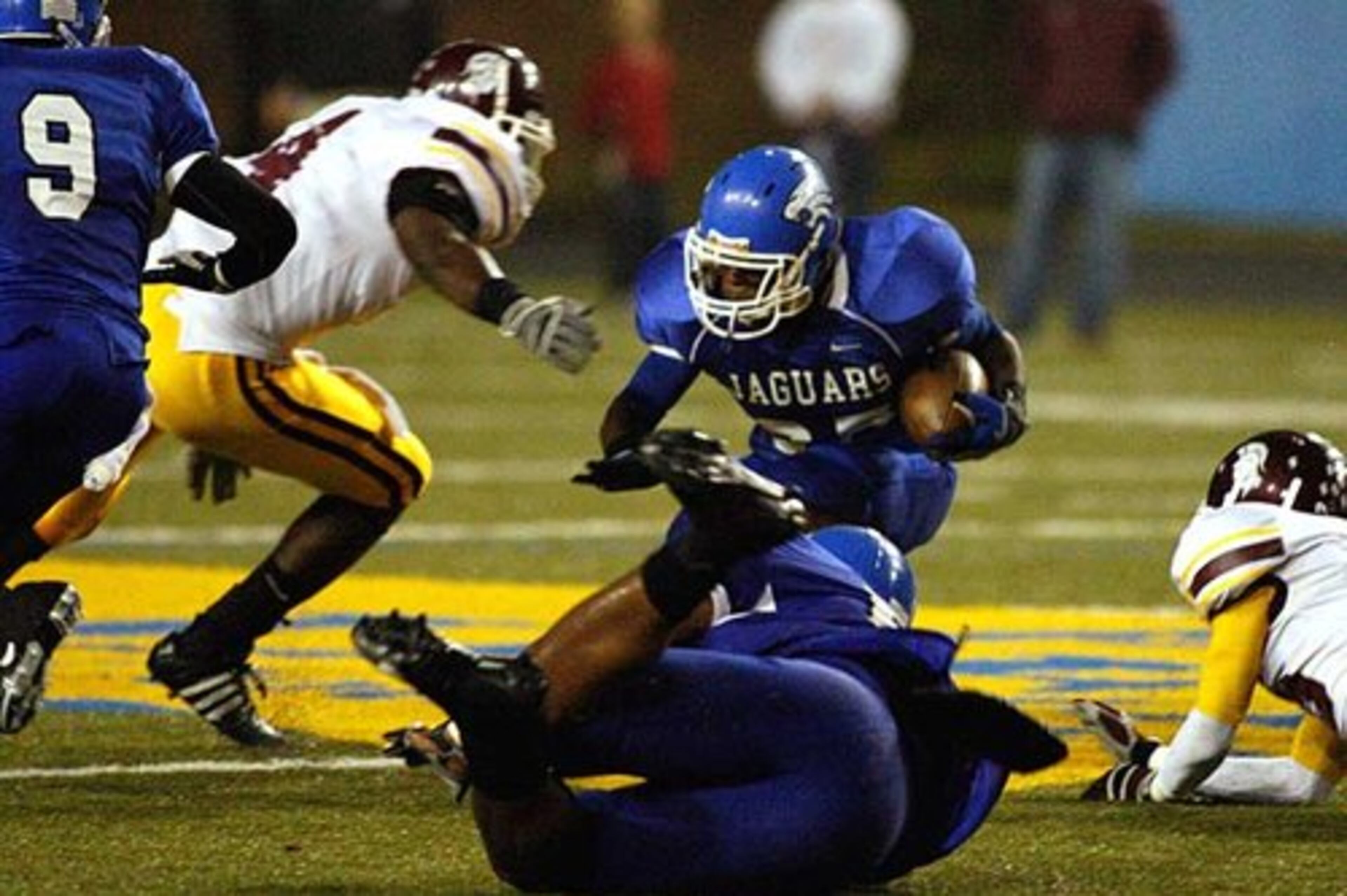 Coffee's D'juan Smith (left) moves in toward Sanders (with ball).
