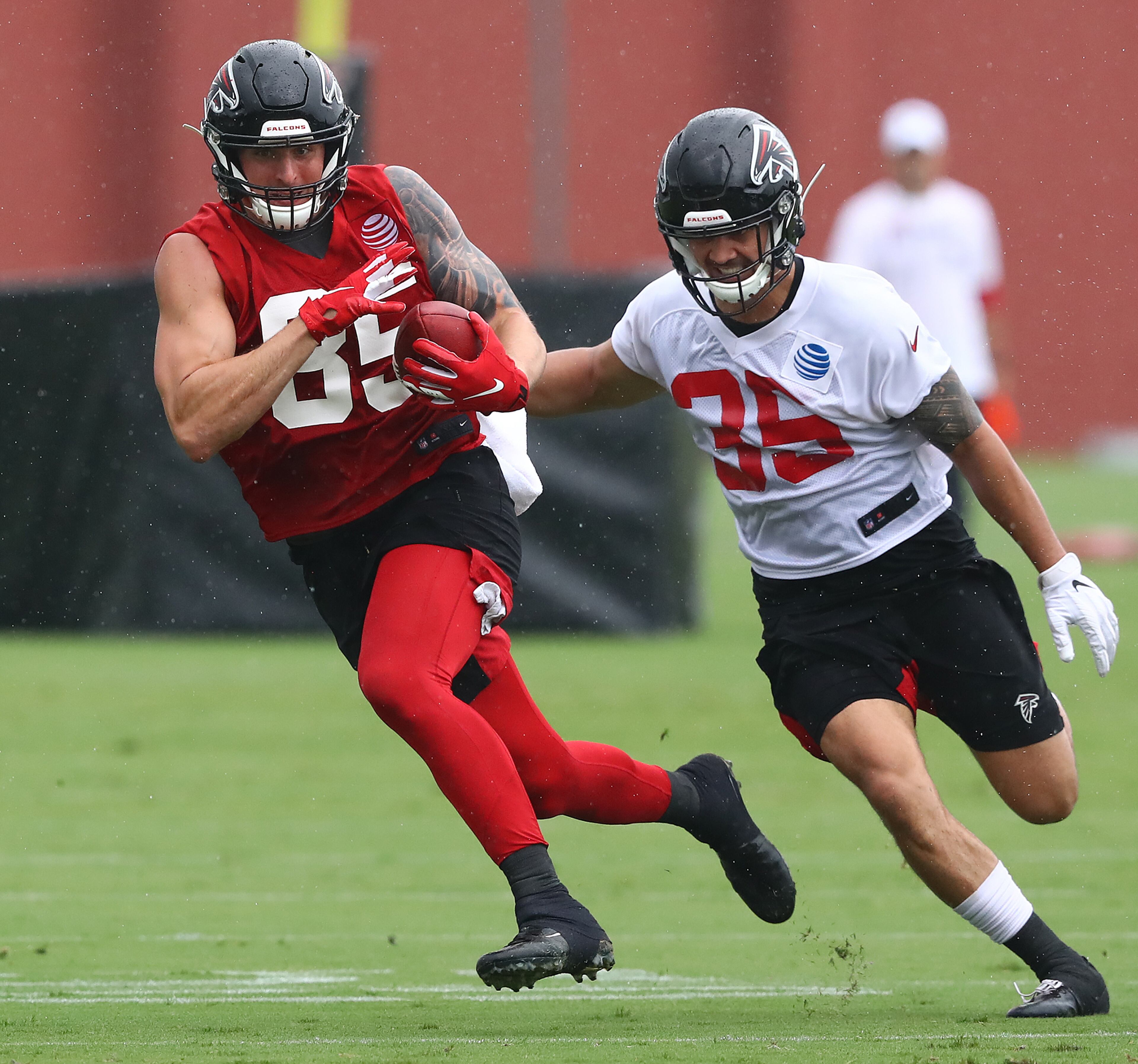 Falcons tight end Eric Saubert makes a catch past safety Jason Thompson. Curtis Compton/ccompton@ajc.com