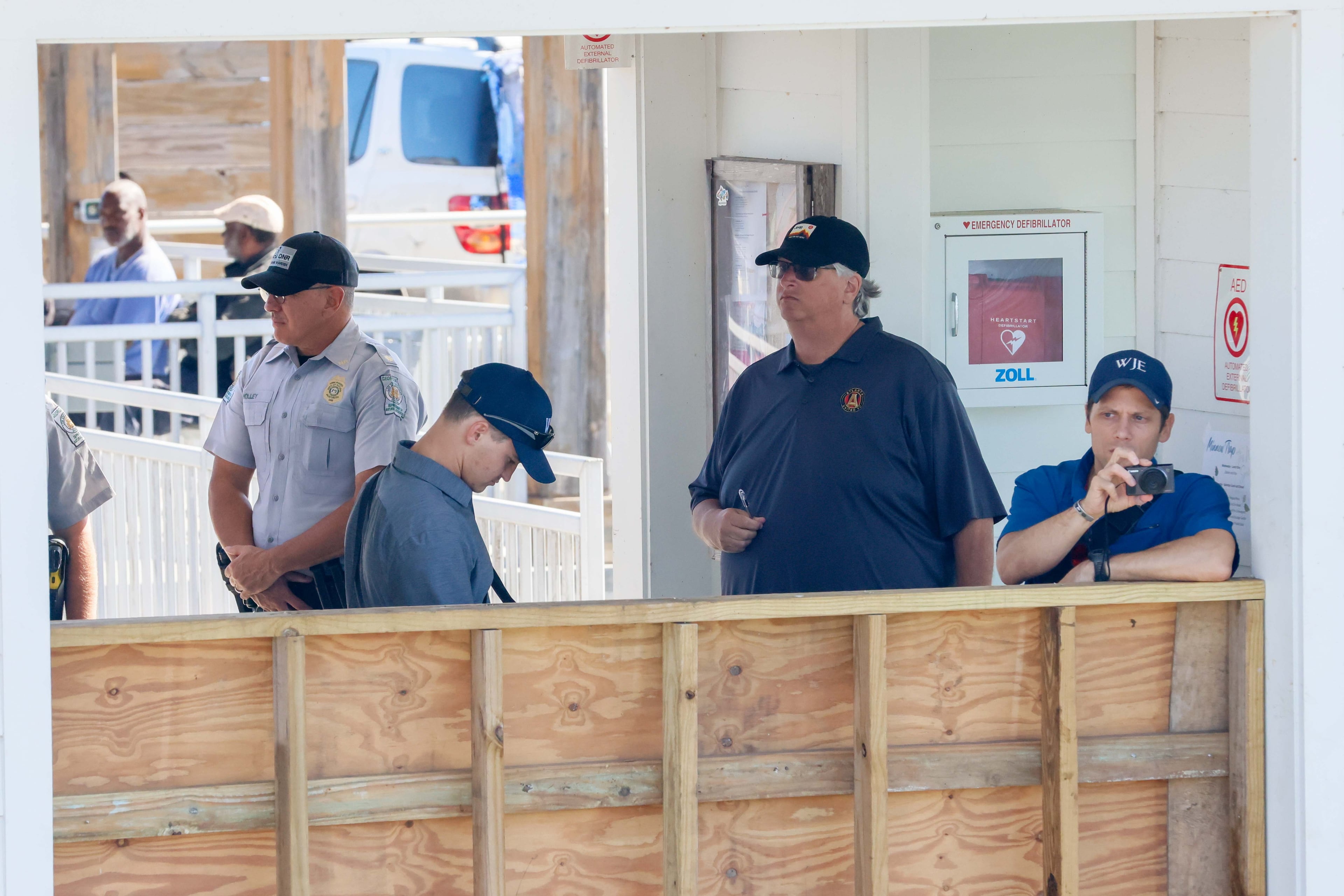 Investigators took photos and studied the pier after a gangway collapsed on Sapelo Island last month, killing seven people.